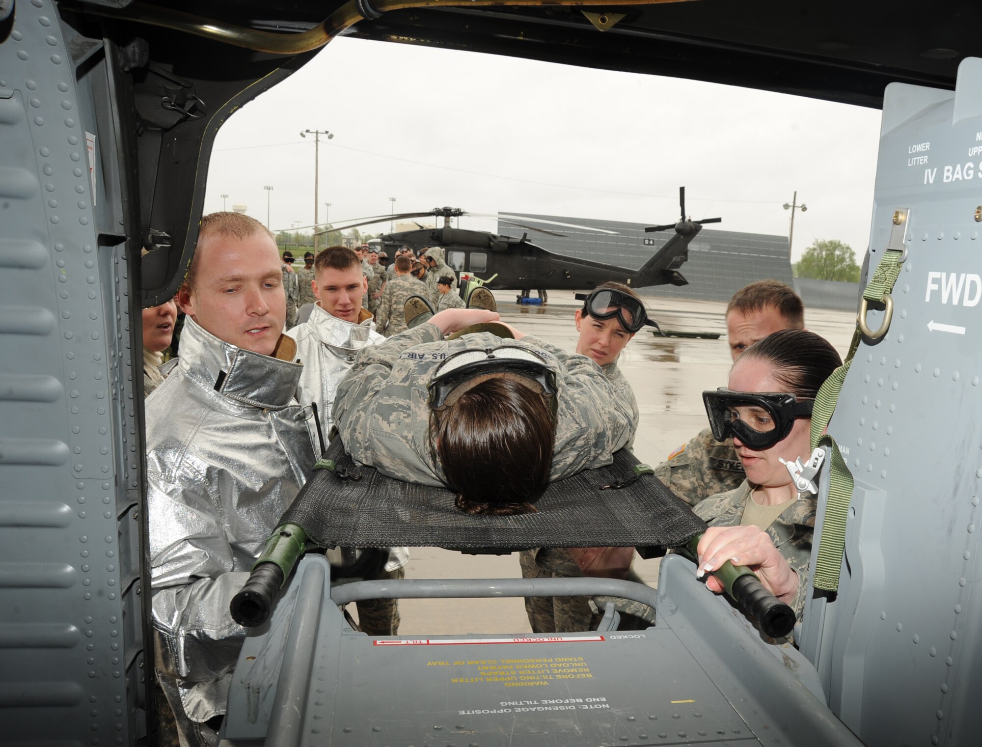 Team McConnell Airmen load a “patient” into a UH-60Q Black Hawk helicopter during an expeditionary medical readiness training on the flightline, April 16, 2010, McConnell Air Force Base, Kan. This joint training familiarized the Airmen with procedures used in emergencies. The exercise prepared the Airmen for medical evacuations in a combat environment.  Airmen from the 22nd Security Forces, 22nd Civil Engineer Squadron fire protection, 22nd CES Explosive Ordnance Disposal and the Air Force Reserve 931st Aerospace Medicine Flight participated in the exercise. (U.S. Air Force photo/Senior Airman Maria Ruiz)