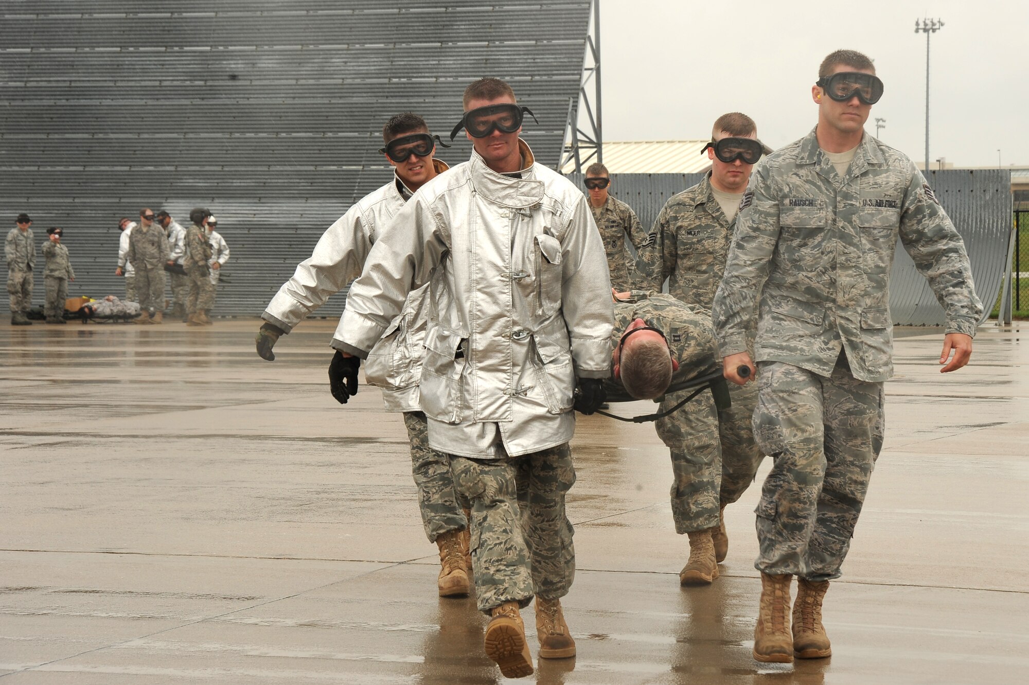 Team McConnell Airmen carry a “victim” to an Army UH-60Q Black Hawk helicopter during a joint medical evacuation exercise April 16, 2010, McConnell Air Force Base, Kan.The 22nd Medical Group, 22nd Security Forces Squadron, 22nd Civil Engineer Squadrons Fire Department, 22nd CES Explosive Ordnance Disposal and Air Force Reserve 931st Aerospace Medicine Flight conducted the exercise with Army Soldiers operating three UH-60Q Black Hawk medevac helos from the Nebraska Army National Guard. The exercise was conducted to train Air Force and Army personnel in a simulated scenario prior to conducting operations in a deployed, hostile environment. (U.S. Air Force photo/Tech. Sgt. Chyrece Campbell)