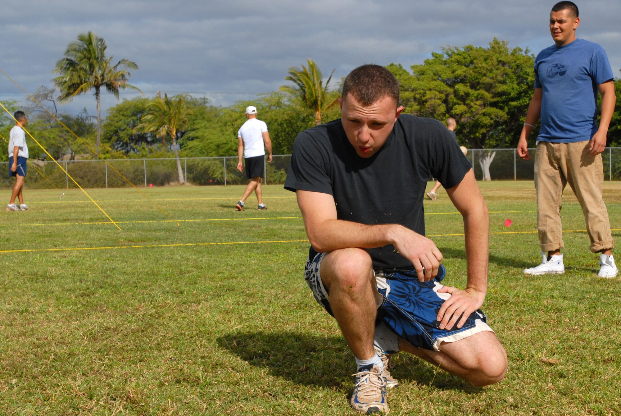 JOINT BASE PEARL HARBOR HICKAM, Hawaii – Senior Airman Jereme Coste, 15th Comptroller Squadron, takes a small breather after attempting to dive for the ball during a volleyball game as part of the Team Hickam Sports Day here, April 16. (U.S. Air Force photo/Senior Airman Gustavo Gonzalez)