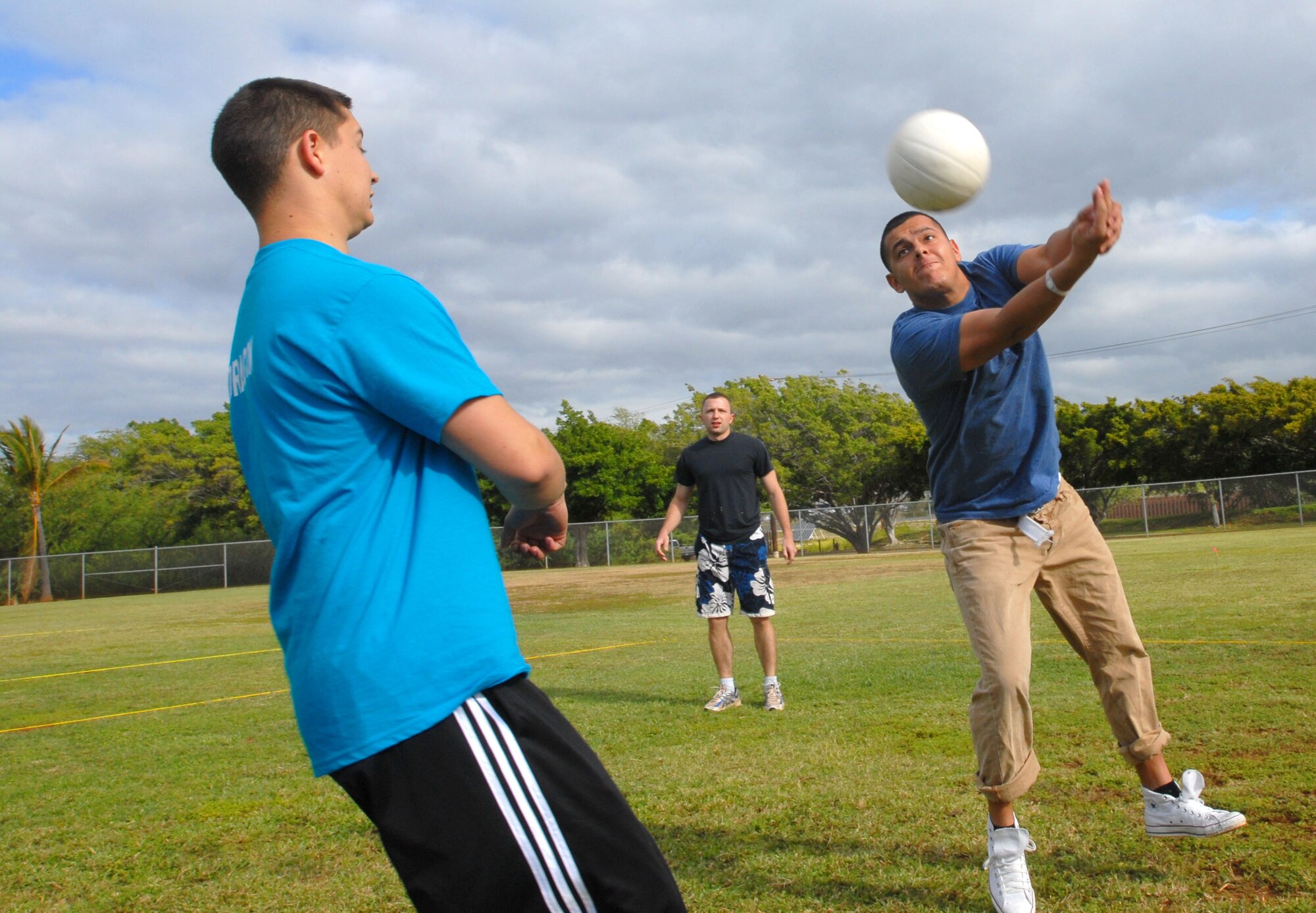 JOINT BASE PEARL HARBOR HICKAM, Hawaii – Senior Airman Andres Aponte, 15th Comptroller Squadron, attempts to hit the ball as his teammate, Senior Airman Zachary Eyl, 15th Comptroller Squadron, gets out of the way during a volleyball game as part of the Team Hickam Sports Day here, April 16. (U.S. Air Force photo/Senior Airman Gustavo Gonzalez)