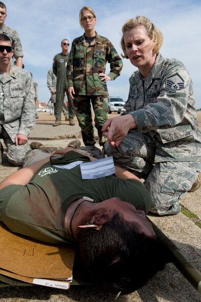 BARKSDALE AIR FORCE BASE, La. –Master Sgt. Pamela Browning, 2d Medical Group, provides care to a simulated casualty during a Major Accident Response Exercise here April 16. The MARE was conducted to test the readiness of emergency response personnel in the event of an accident during the upcoming air show. (U.S. Air Force photo by Airman 1st Class Chad Warren) (RELEASED)