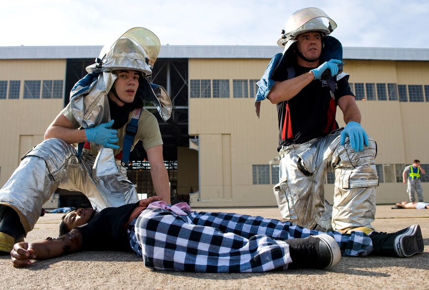 BARKSDALE AIR FORCE BASE, La. – Firefighters assigned to the 2d Civil Engineer Squadron provide care to a simulated casualty during a Major Accident Response Exercise here April 16. The MARE was conducted to test the readiness of emergency response personnel in the event of an accident during the upcoming air show. (U.S. Air Force photo by Airman 1st Class Chad Warren) (RELEASED)
