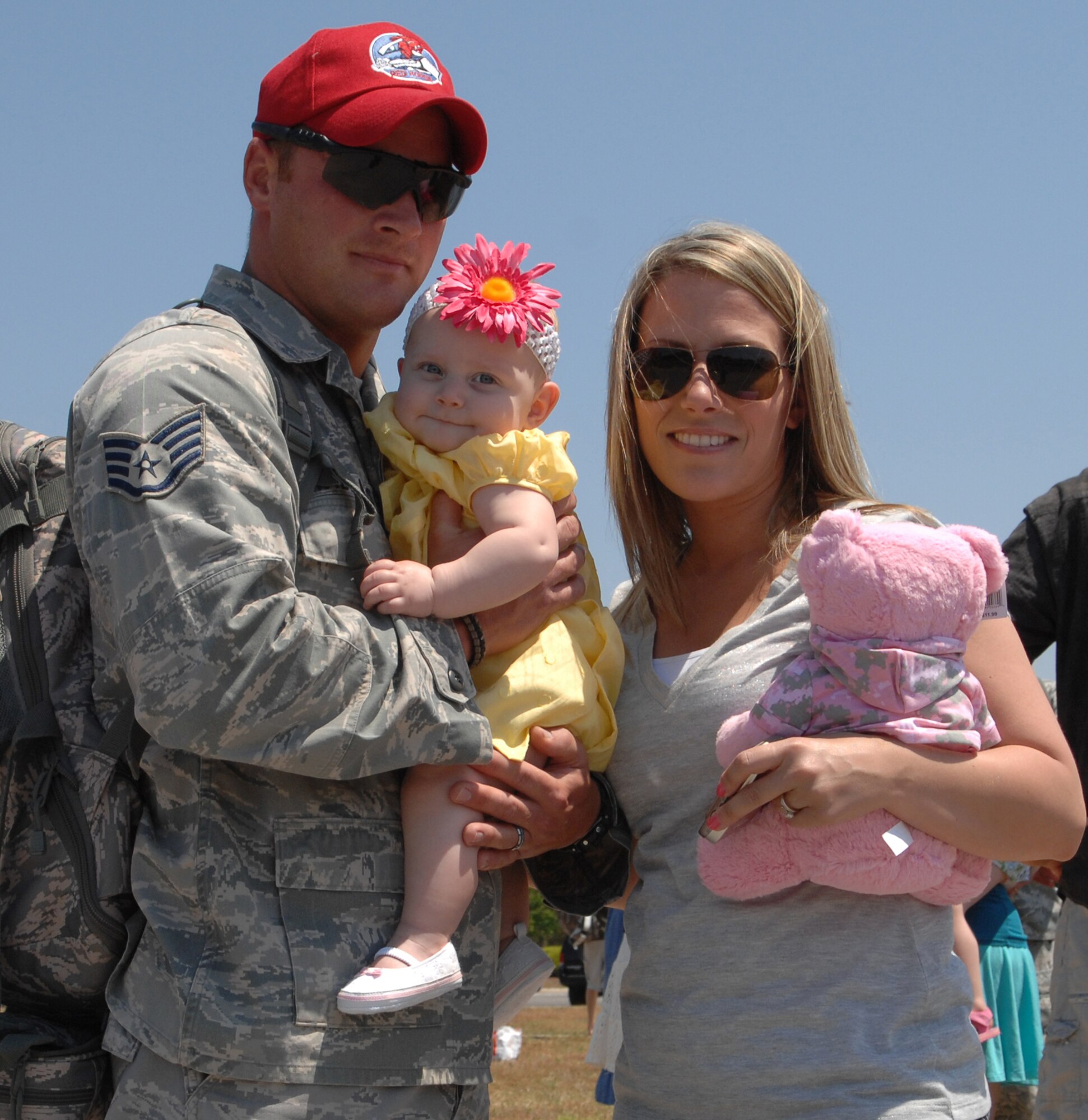 Staff Sgt. Joel Williamson, 823rd RED HORSE Squadron, is welcomed home by his wife Tara and daughter Reagan, April 15, 2010, Hurlburt Field, Fla.RED HORSE returned from a six-month deployment to SW Asia.(DoD photo by U.S. Air Force Master Sgt Scott MacKay)(RELEASED)