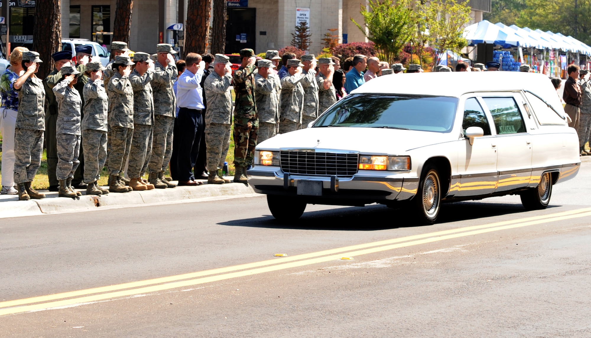 Team Hurlburt members from across the base line the streets, saluting the Hearse carrying Senior Master Sgt. James Lackey as he is transported to the Hurlburt Field Airpark for his funeral April 16.  Sergeant Lackey died in the line of duty when his CV-22 crashed in Afghanistan April 9. (DoD photo by Airman Caitlin O'neil-McKeown)