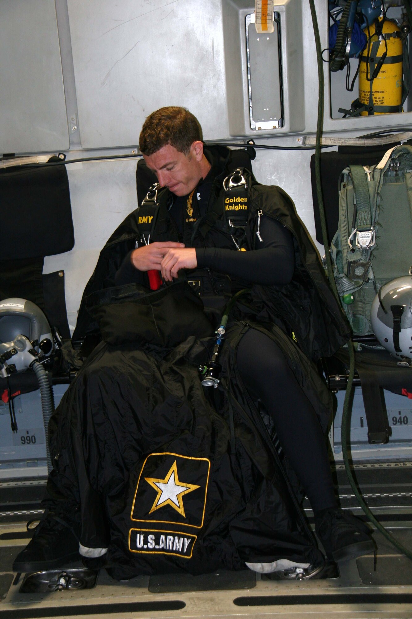 ALTUS AIR FORCE BASE, Okla. -- U.S. Army Staff Sgt. Ben Borger of the U.S. Army parachute team known as the Golden Knights checks over his wing-suit before attempting to set a new world wing-suit distance record over Altus Air Force Base April 14. With the assistance of the Altus C-17 Globemaster III crew, Sergeant Borger jumped out of the plane at an altitude of 32,000 feet. He broke the record by a mile and a half and is currently awaiting confirmation of the new set record from the Guinness Book of World Records. (U.S. Army Courtesy Photo/Released Golden Knights)