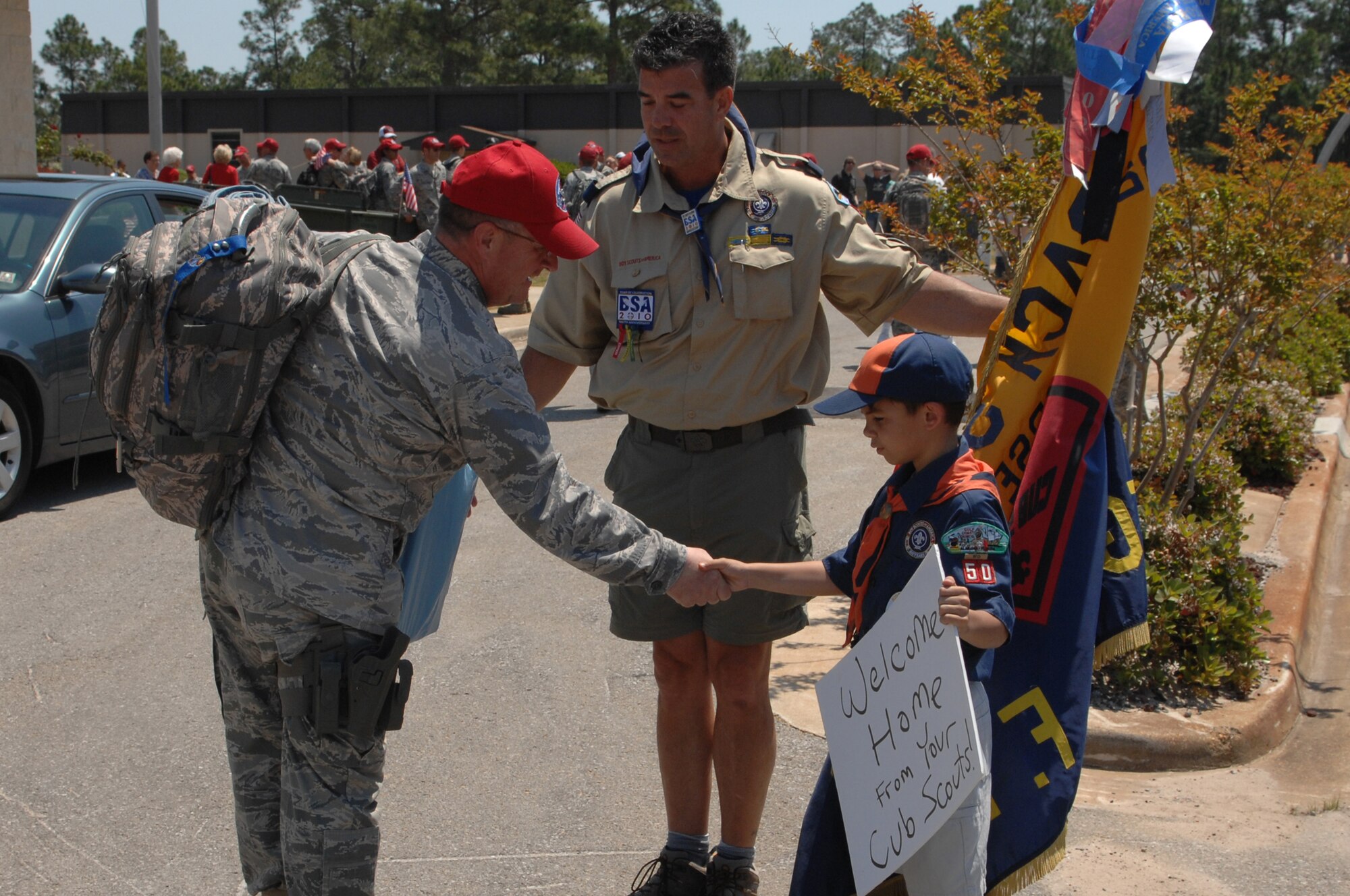 Col. Douglas Tucker, 823rd RED HORSE commander, greets Cub Scout Leader Michael Rivera and his son, Joel, upon returning from deployment April 15, 2010, Hurlburt Field, Fla. Cub Scout Pack 50 is sponsored by the RED HORSE booster club. (DoD photo by U.S. Air Force Master Sgt. Scott MacKay)(RELEASED)