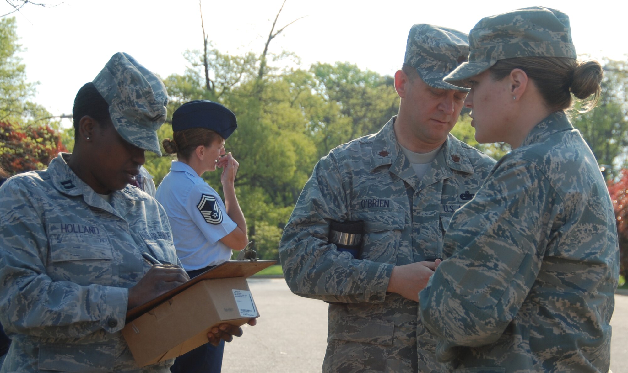 Capt. Aletha Holland, 459th Mission Support Group executive officer takes personnel reports for accountability during a fire drill here, April 16. (U.S. Air Force photos/Senior Airman Amber Russell)