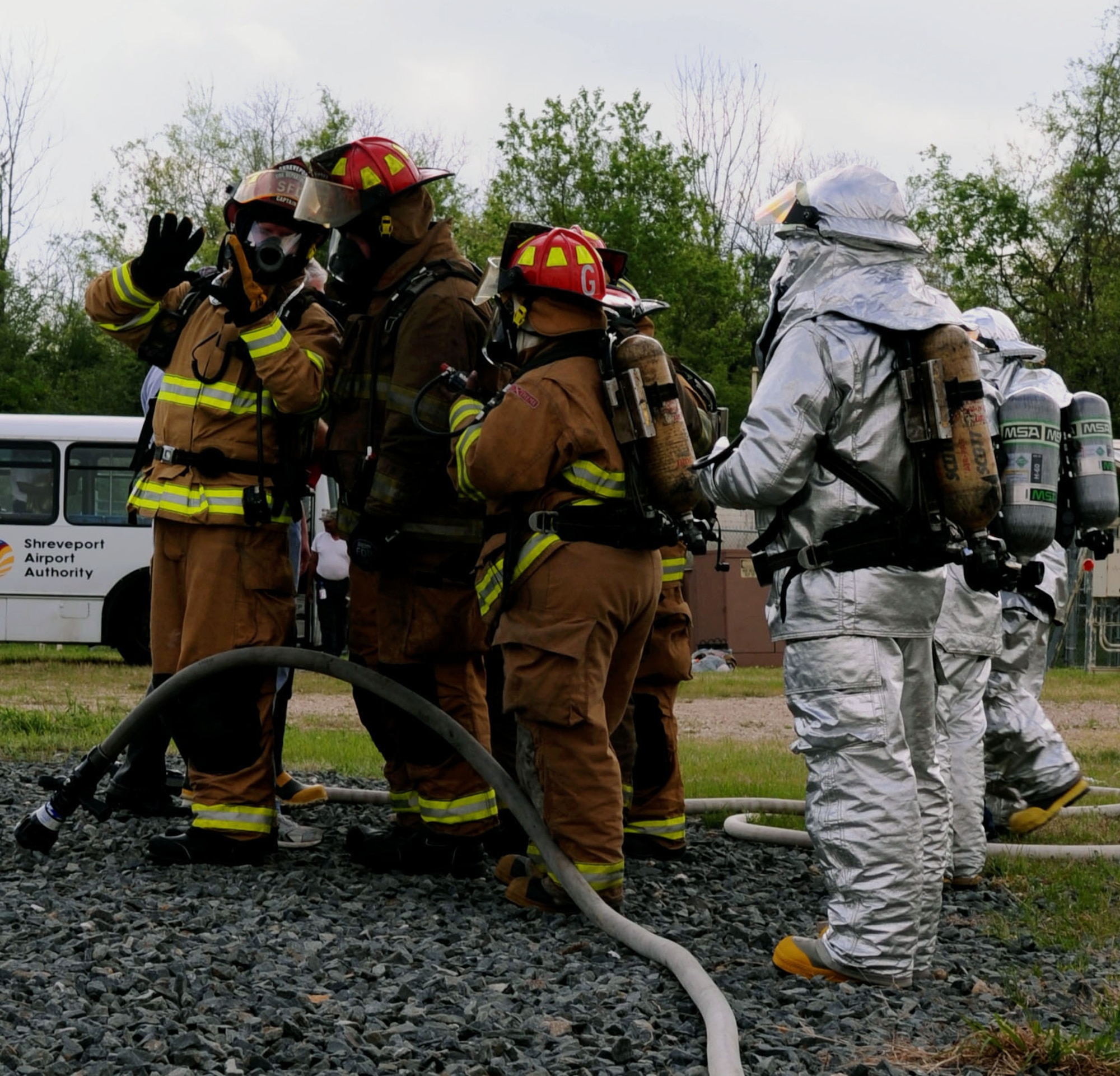 BARKSDALE AIR FORCE BASE, La. – Barksdale and Shreveport firefighters discuss their plans as they prepare for their annual joint - live fire training here April 7. Firefighters wear proximity firefighting gear since there is no training gear for this purpose. The special aluminized cover and barrier help reflect some heat away from the Firefighters while the self – contained breathing apparatus allows them to breathe clean air for approximately 40 minutes in working conditions. (U.S. Air Force photo by Senior Airman La’Shanette V. Garrett)(RELEASED)