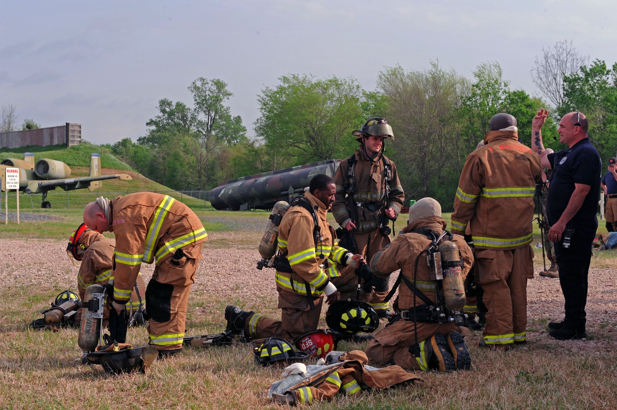 BARKSDALE AIR FORCE BASE, La. – Shreveport firefighters gear - up as they prepare for their annual joint - live fire training here April 7. Firefighters wear proximity firefighting gear since there is no training gear for this purpose. The special aluminized cover and barrier help reflect some heat away from the firefighters while the self – contained breathing apparatus allows them to breathe clean air for approximately 40 minutes in working conditions. (U.S. Air Force photo by Senior Airman La’Shanette V. Garrett)(RELEASED)