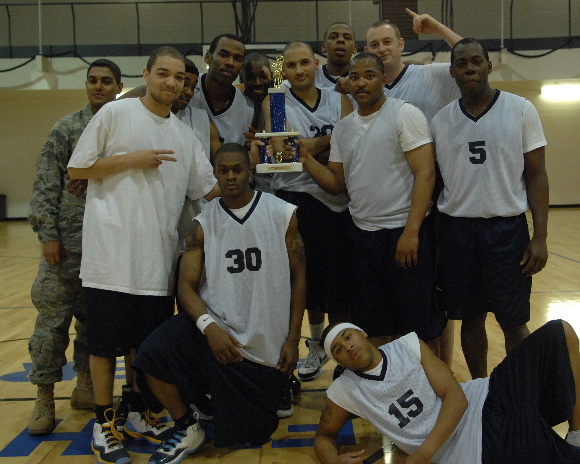 HOLLOMAN AIR FORCE BASE, N.M. -- The 2010 Holloman Intramural Basketball Champions accept the first place trophy March 19. The 49th FSS lost only one game the entire season and went on to win the championship over the 49th OG. The Domenici Fitness and Sports Center offers Team Holloman members a wide range of intramural team sports including basketball, football, volleyball and soccer. (U.S. Air Force photo by Airman 1st Class Joshua Turner / Released)