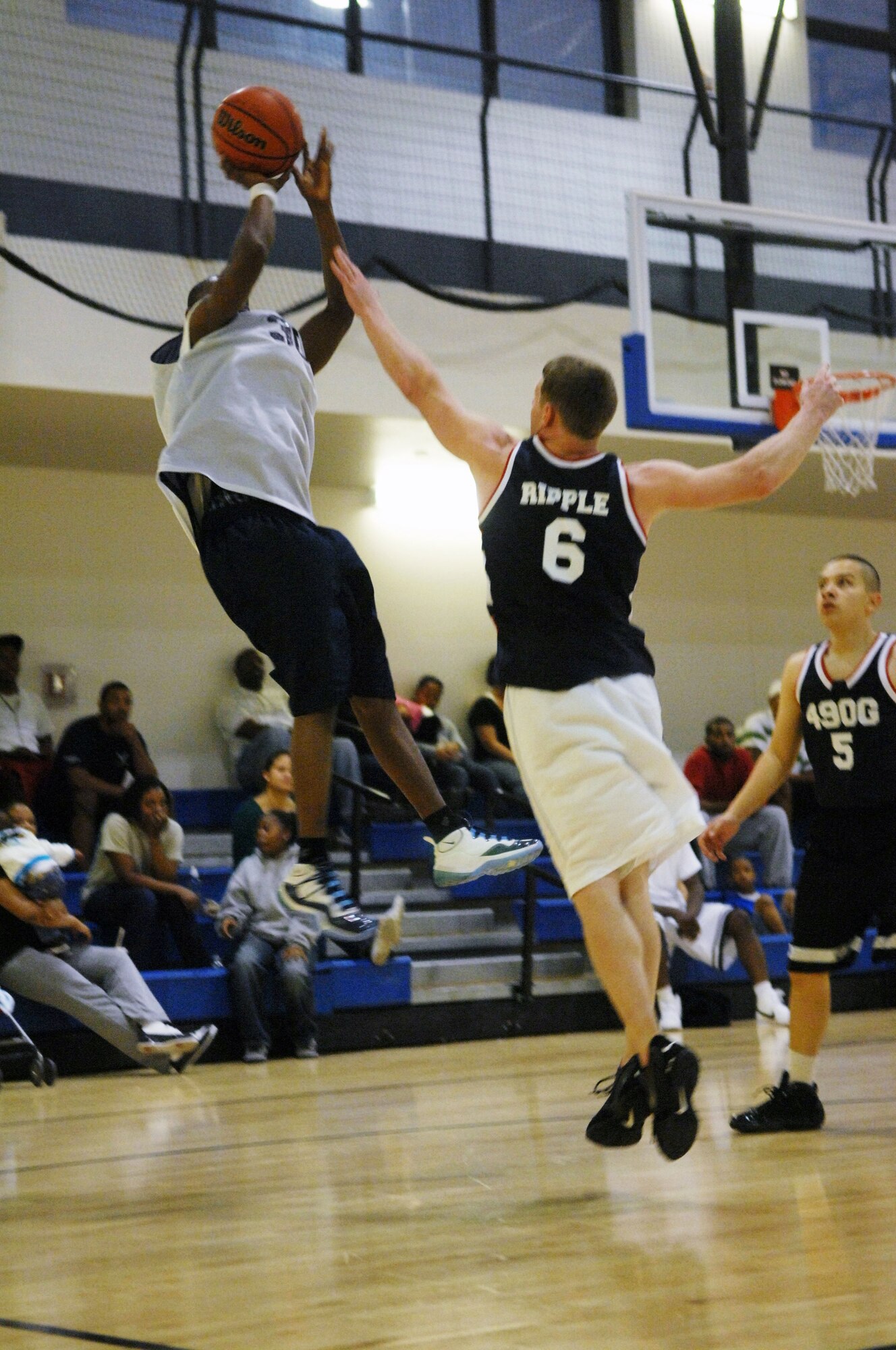 HOLLOMAN AIR FORCE BASE, N.M -- Jared Hughies, forward and guard for the 49th Force Support Squadron Team A, takes a jump shot against the 49th Operations Group March 19, 2010, during the Holloman Intramural Basketball Championship. The 49th FSS lost only one game the entire season and went on to win the championship 42-36 over the 49th OG. The Domenici Fitness and Sports Center offers Team Holloman members a wide range of intramural team sports including basketball, football, volleyball and soccer. (U.S. Air Force photo by Airman 1st Class Joshua Turner / Released)
