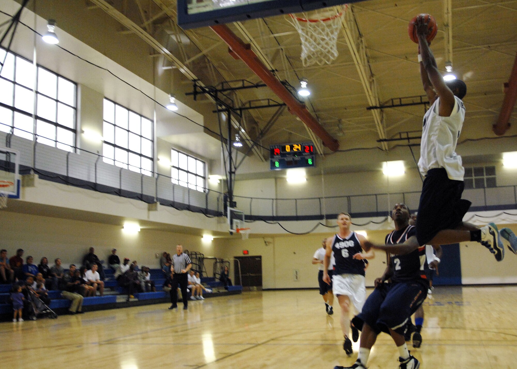 HOLLOMAN AIR FORCE BASE, N.M. -- Jared Hughies, forward and guard for the 49th Force Support Squadron Team A, goes up for a dunk against the 49th Operations Group March 19, 2010, during the Holloman Intramural Basketball Championship. The 49th FSS lost only one game the entire season and went on to win the championship 42-36 over the 49th OG. The Domenici Fitness and Sports Center offers Team Holloman members a wide range of intramural team sports including basketball, football, volleyball and soccer. (U.S. Air Force photo by Airman 1st Class Joshua Turner / Released)