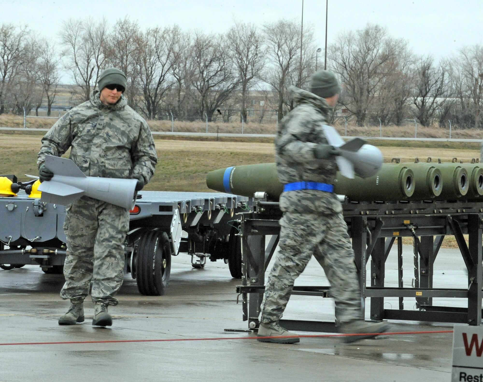 Load crew members attach the fins to conventional bombs in a load crew competition April 13, 2010, at Minot Air Force Base, N.D. (U.S. Air Force photo/Staff Sgt. Stacy Moless)