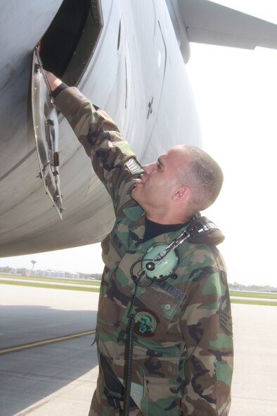 WRIGHT-PATTERSON AIR FORCE BASE, Ohio - Staff Sgt. Shawn Johnson, 445th Aircraft Maintenance Squadron, is checking the oil for the auxiliary power unit in a C-5 Galaxy while preparing the aircraft for a mission April 12. (U.S. Air Force photo/Staff Sgt. Amanda Duncan)