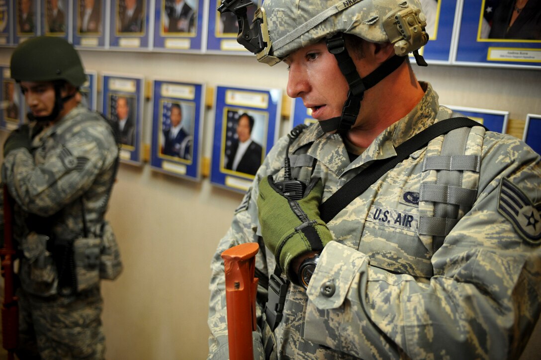 (Right) Staff Sgt. George Brodish, 28th Security Forces Squadron patrolman, responds to his radio during an “active shooter” exercise, April 15. During the exercise Airmen from the 28 SFS were tested on their ability to respond in a timely manner. (U.S. Air Force photo/Senior Airman Adam Grant)       