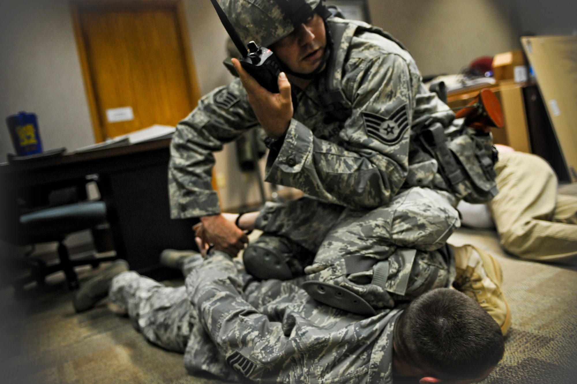 Staff Sgt. Mark Sidle, 28th Security Forces Squadron dog handler, apprehends Tech. Sgt. Aaron Hazen, 28th Bomb Wing NCO in-charge of the executive client support team, during an “active shooter” exercise, April 15. The purpose of the exercise was to test the total reaction and response time of the 28 BW. (U.S. Air Force photo/Senior Airman Adam Grant)            