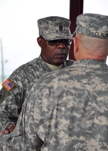 Army Support Activity Command Sgt. Maj.  Clayton Crooks, receives the unit sword from Col. Martin Clausen, ASA Commander during a change of responsibility ceremony April 14 at Soto Cano Air Force Base, Honduras.  