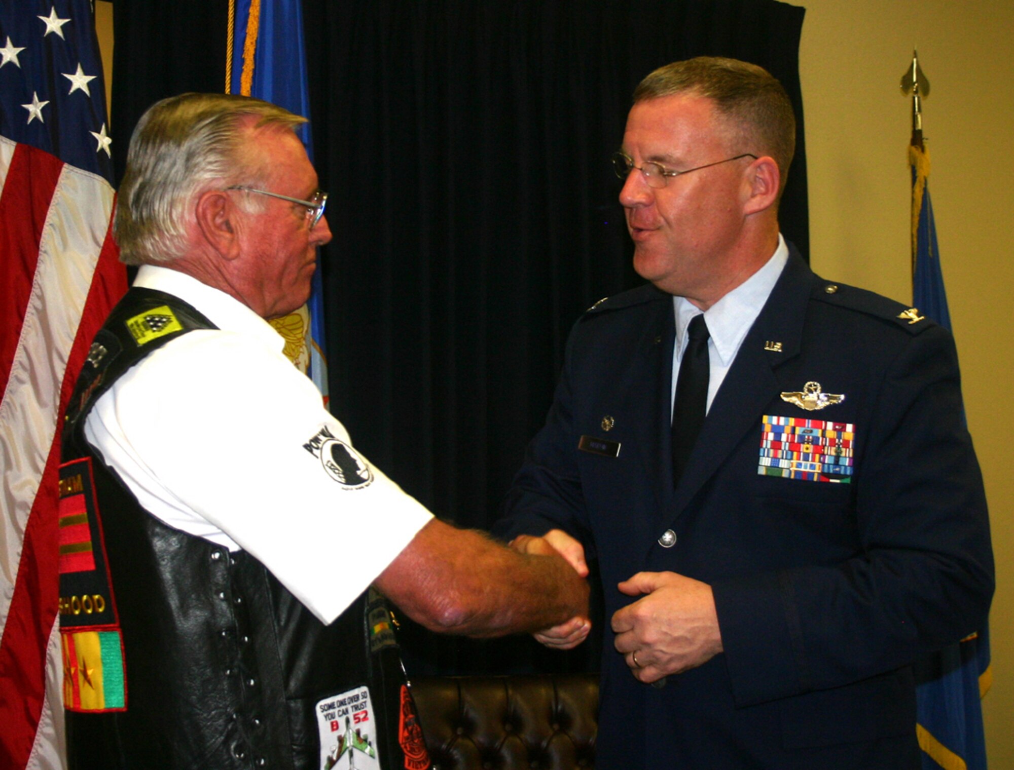 Former Staff Sgt. Jerry Kmieciak is congratulated by Col. Larry Martin, 6th Air Mobility Wing commander in a belated Purple Heart ceremony April 10 at MacDill Air Force Base.