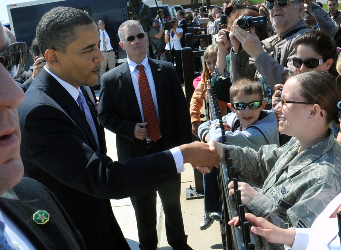 President Barack Obama shakes the hand of Senior Airman Katie Spencer, a Joint Base Andrews Nuclear Security Summit Media Operations Center media escort, during an impromptu stop to thank military and civilian team members for their work supporting his summit April 9 through Thursday.  Airman Spencer is a Reserve augmentee in the 316th Wing Public Affairs Office from the 482nd Fighter Wing, Homestead Air Reserve Base, Fla. The president walked to the fence line adjacent to the flight line before boarding Air Force One to fly to Cape Canaveral, Fla. (U.S. Air Force photo by Bobby Jones)
