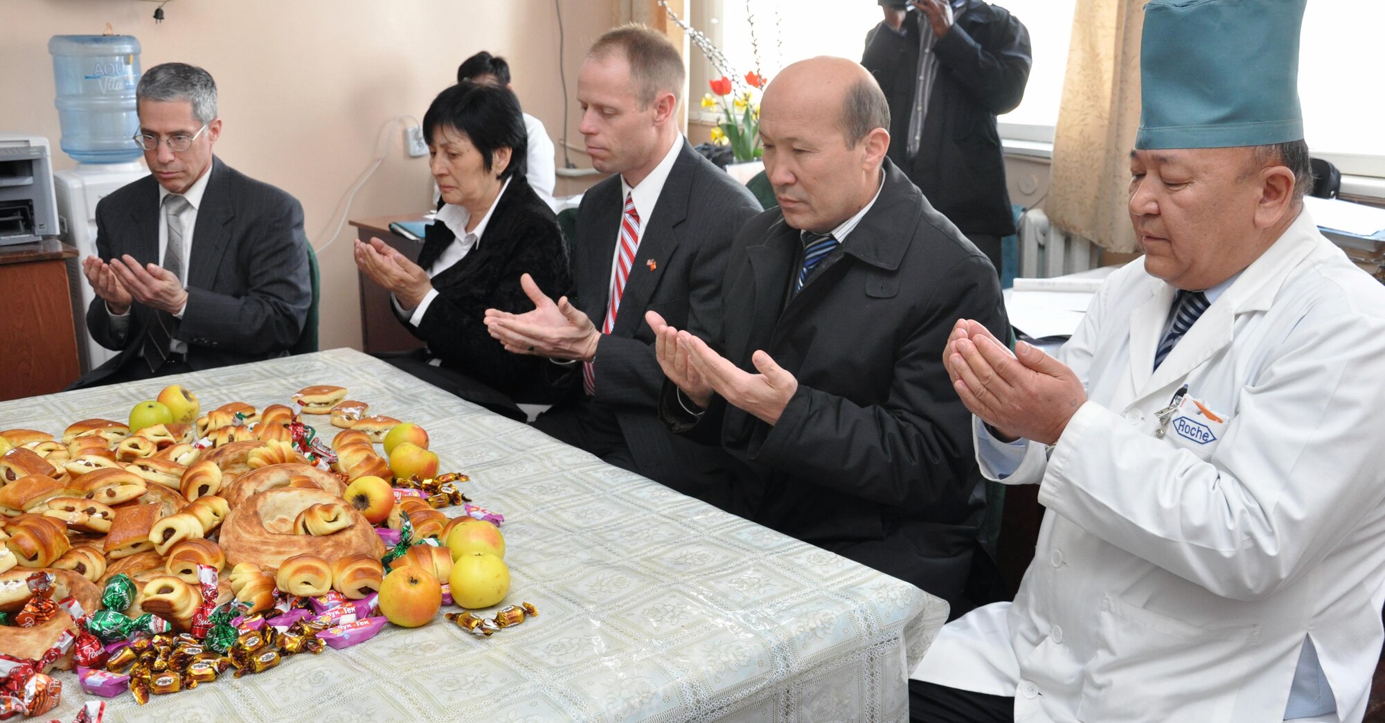 (Left to right) Transit Center at Manas personnel Col. Jerry Flyer, Valentina Turabekova, and Col. Blaine Holt participate in a prayer at the National Hospital in Bishkek, Kyrgyzstan, April 15, 2010. Airmen delivered $82,000 worth of medical supplies and food to two Bishkek hospitals April 15, 2010, and visited with patients who were injured in last week?s unrest. A total of four hospitals were helped with these supplies. (U.S. Air Force photo/Staff Sgt. Carolyn Viss)