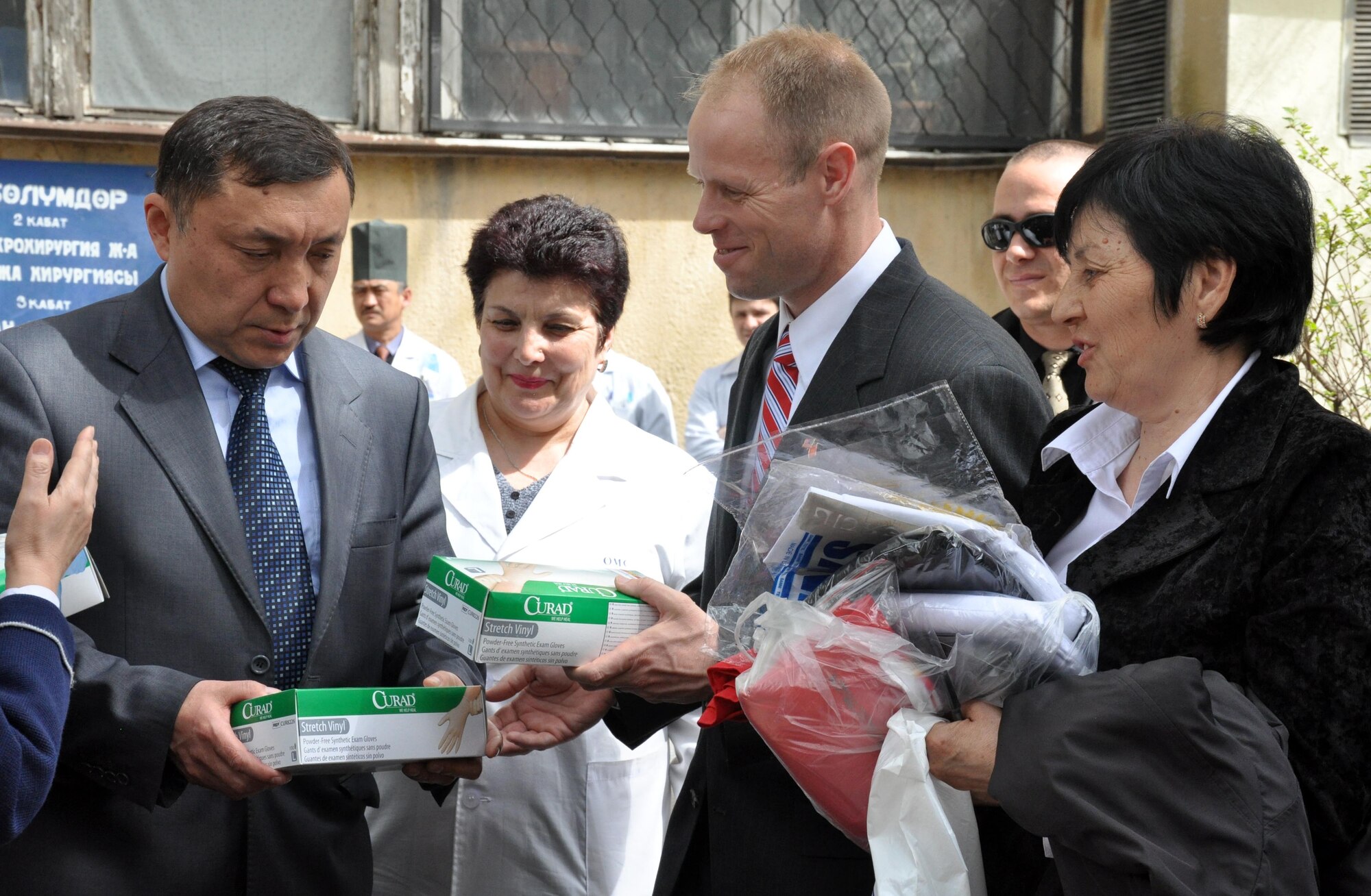 Col. Blaine Holt, director of the Transit Center at Manas, Kyrgyzstan, center, hands donated medical supplies to Deputy Minister of Health, Mr. Madamim Karataev, at the National Hospital in Bishkek April 15, 2010. (U.S. Air Force photo/Staff Sgt. Carolyn Viss)