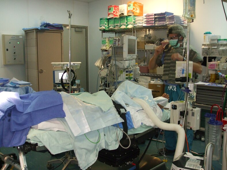 Maj. Jeffrey Rengel, 88th Air Base Wing Medical Center’s surgical operation squadron, wears a flak vest and helmet for protection in the operating room at Bagram Airfield, Afghanistan.  Major Rengel played an integral role in removing an unexploded ordnance from the head of an Afghan soldier.
