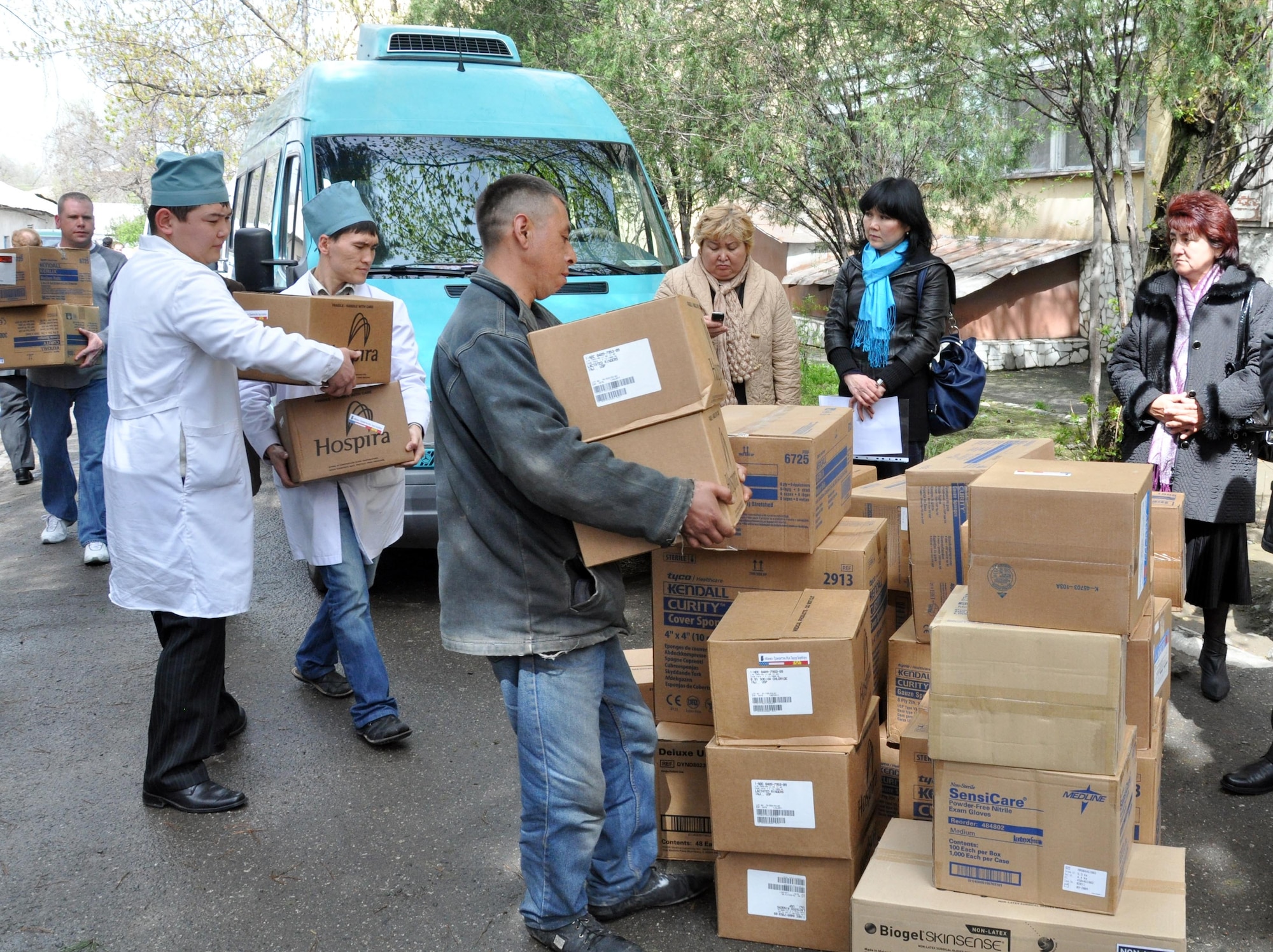 Kyrgyz medical doctors from the National Hospital in Bishkek, Kyrgyzstan, help carry medical supplies donated by the Transit Center at Manas April 15, 2010. This is a continuation of efforts started just a couple of days ago when 16,000lbs ? approximately $82,000 worth ? of supplies including bandages, sutures, antibiotics, and antiseptics, were delivered to the Transit Center at Manas from the U.S. Army Medical Material Center, Southwest Asia. A total of four hospitals were helped with these supplies. (U.S. Air Force photo/Staff Sgt. Carolyn Viss)