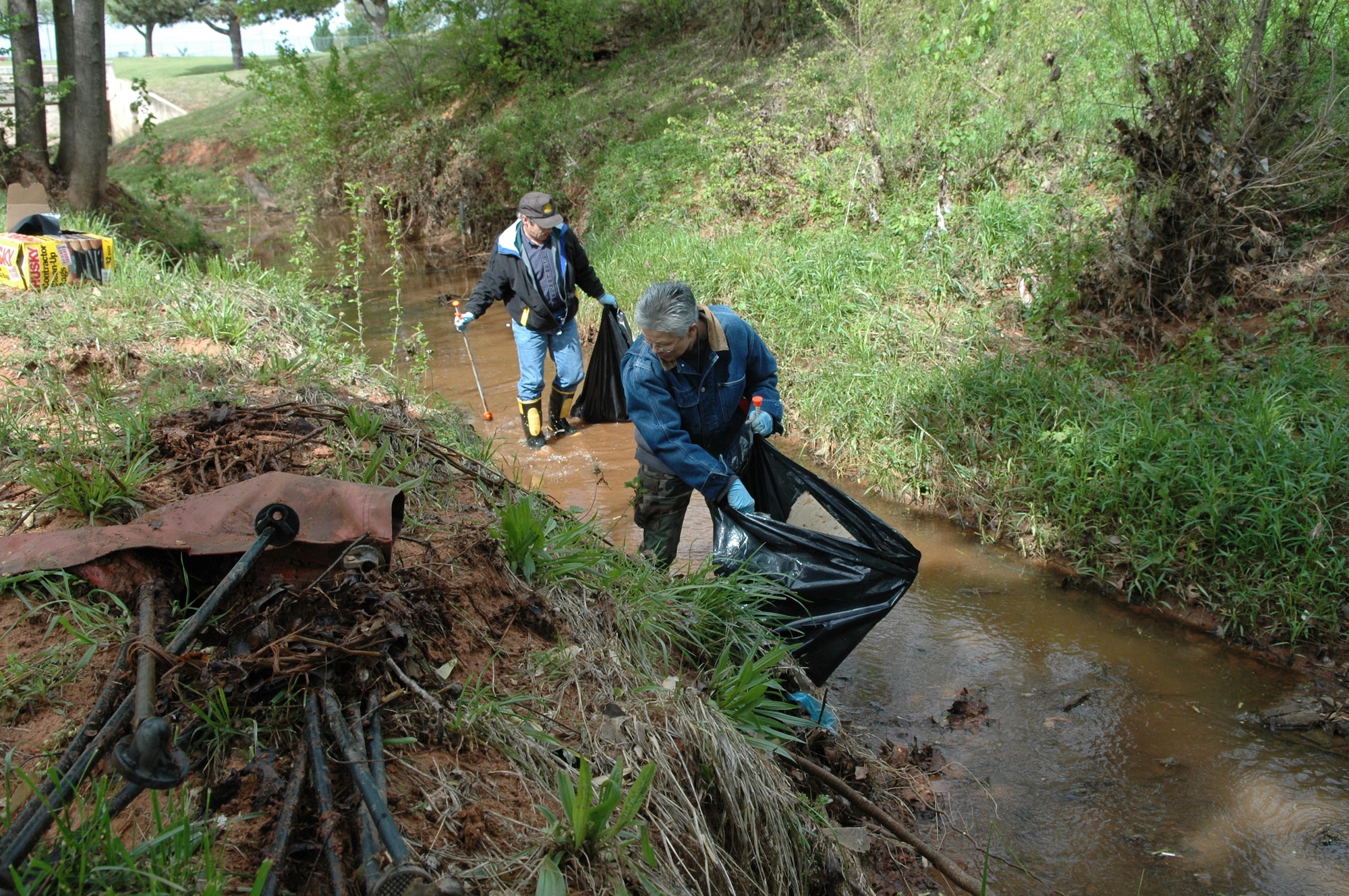 Volunteers clean up a creek system at Tinker by removing trash and debris during the annual Spring Creek Cleanup last year. One day after Earth Day, the 72nd Civil Engineering Group is looking for volunteers to collect trash along the corridors of creek systems on base again this year. The event is planned for 11 a.m. to 4 p.m. April 23.  Volunteers are asked to meet in the Environmental Conference Room at Bldg. 1, Room 210. Lunch, refreshments, and transportation to the creeks will be provided.  Volunteers are asked to wear a long sleeve shirt, pants, and closed toes shoes. Trash gabbers, bags, and gloves will also be provided to volunteers.To volunteer or for more information, call Tinker’s Storm Water Program manager at 734-1228 or e-mail  john.truong @tinker.af.mil.
