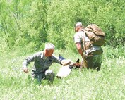 Chico, a combat tracker dog, attacks the arm of Col. William H. Mott V, 37th Training Wing commander, after tracking and locating the commander during a field demonstration April 8 at the Lackland Training Annex. Chico and his handler, Marine Staff Sgt. Aaron Nuckles, graduated from the Department of Defense’s combat tracker dog program at Lackland April 9. (U.S. Air Force photo/Alan Boedeker)