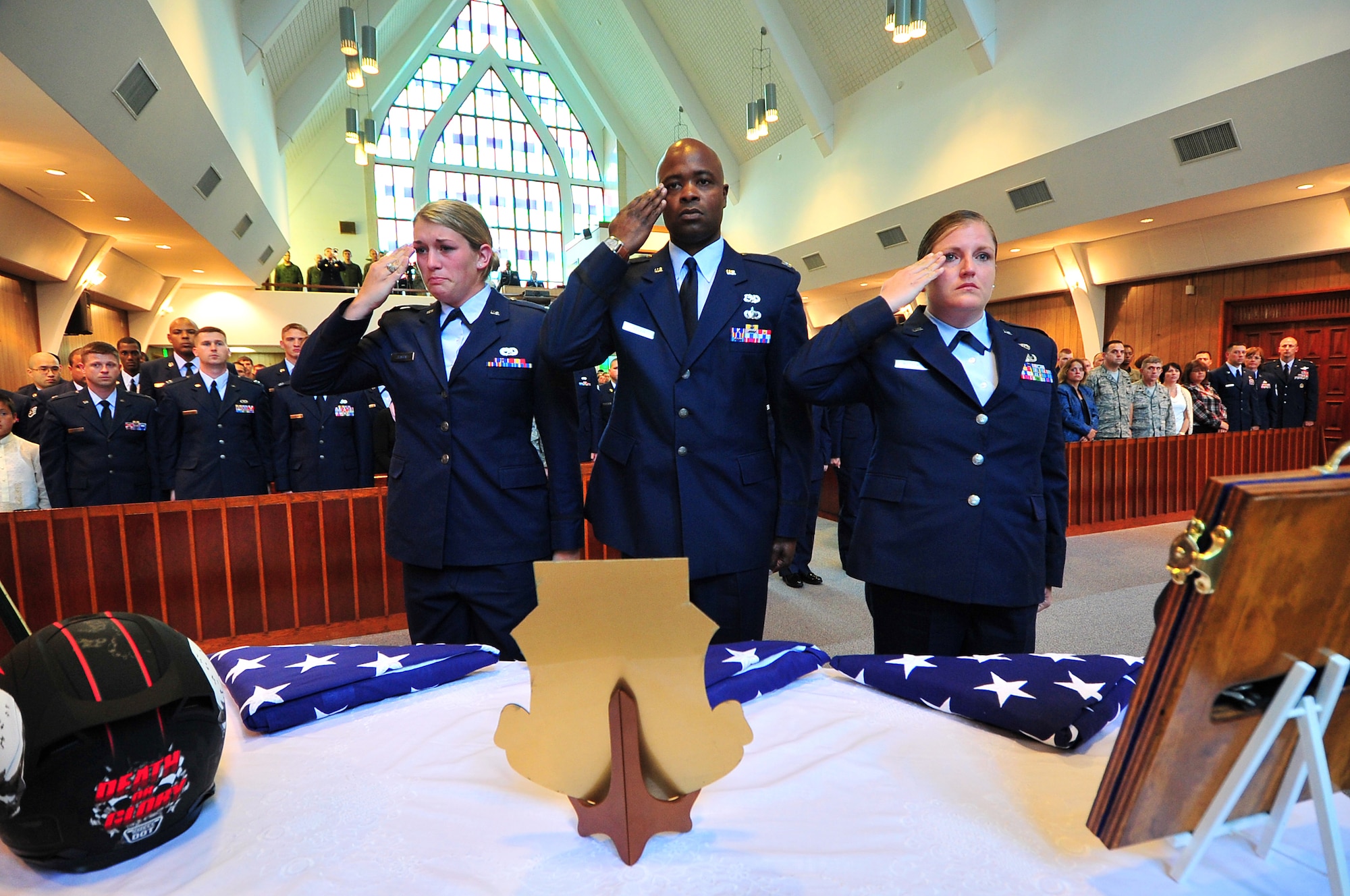KADENA AIR BASE, Japan -- Officers of the 353rd Maintenance Squadron give a final salute to flags flown on MC-130s for the family of 2nd Lt. Stephen Smith to maintenance officers during a memorial service here April 15. The 28-year-old lieutenant, a maintenance officer with the 353rd MXS, was found dead the morning of April 11 near Cape Hedo, Okinawa, after going missing while snorkeling with friends April 10. (U.S. Air Force photo by Tech. Sgt. Rey Ramon)