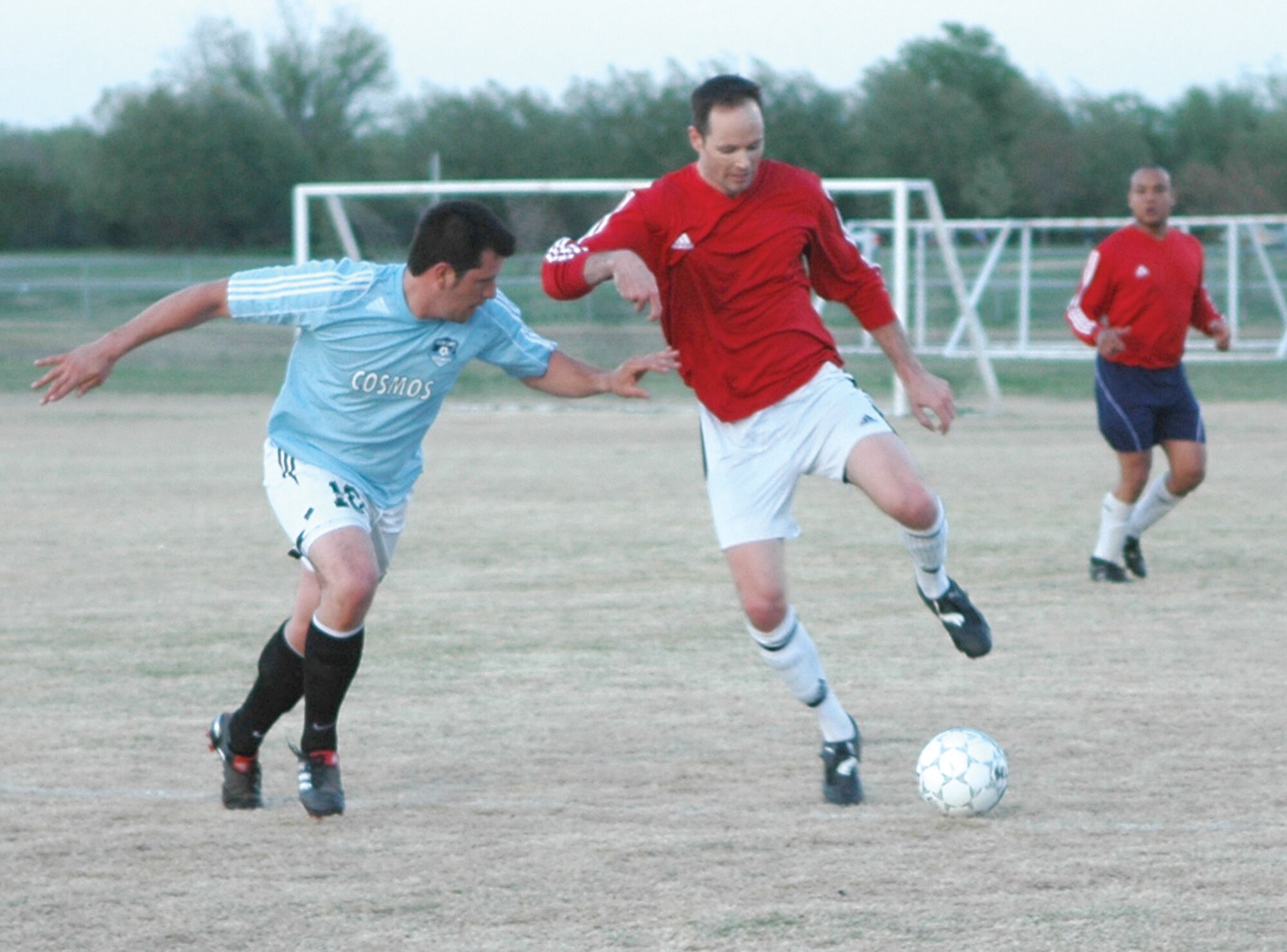 Tinker’s Peter Davis carries the ball down field while fending off a Cosmos defender. The captain with the 552nd Training Squadron and his varsity soccer teammates beat the Cosmos 1-0 April 11. (Air Force photo by Brandice J. Armstrong)
