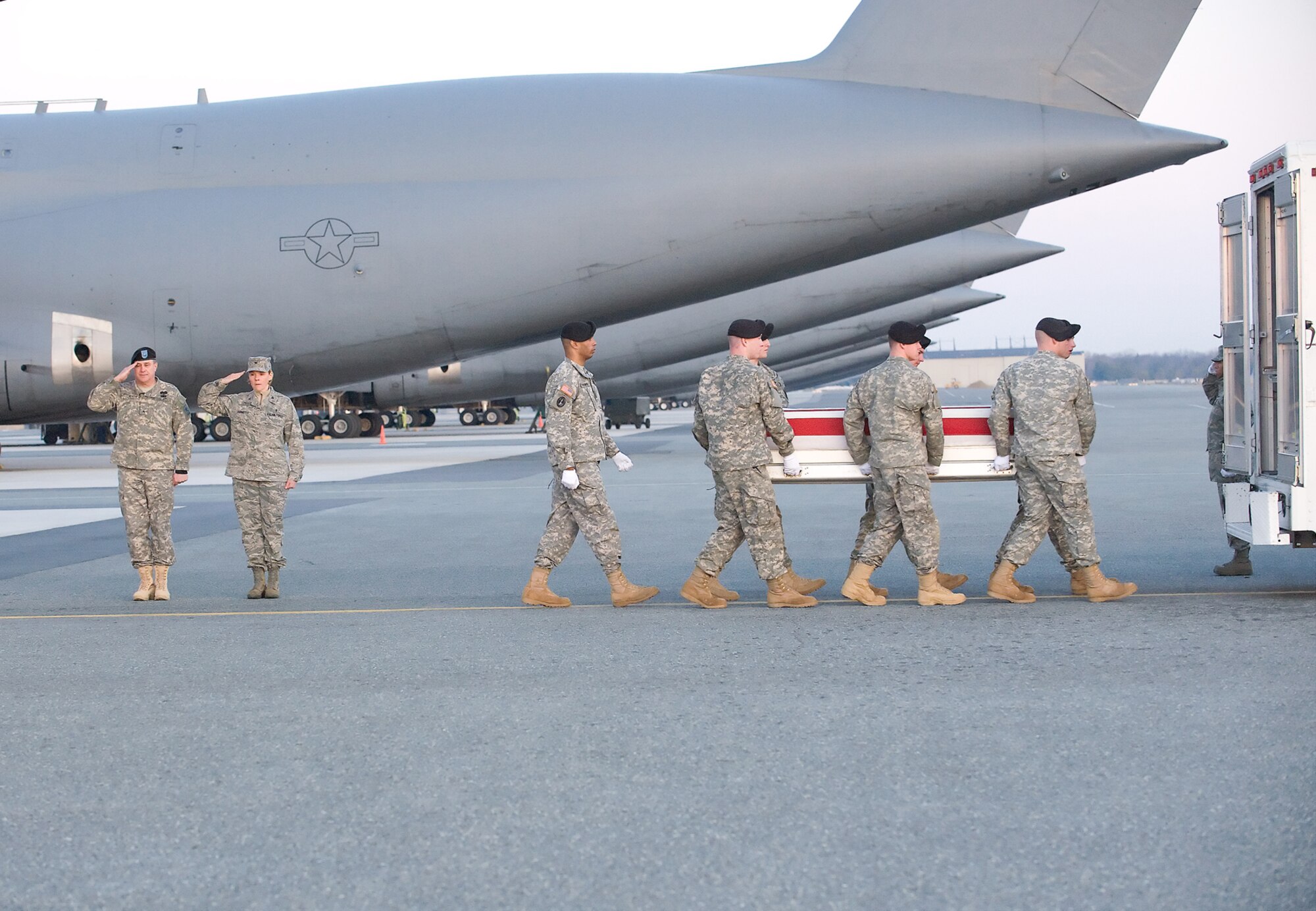 A U.S. Army carry team transfers the remains of Army Private 2nd Class Nicholas S. Cook of Hungry Horse, Mont., at Dover Air Force Base, Del., on March 9, 2010. PV2 Cook was assigned to the Company B, 2nd Battalion, 503d Infantry at Camp Elderle in Italy. He died March 7 in Konar province, Afghanistan, of wounds sustained when insurgents attacked his unit using small arms fire. (U.S. Air Force photo/Brianne Zimny)