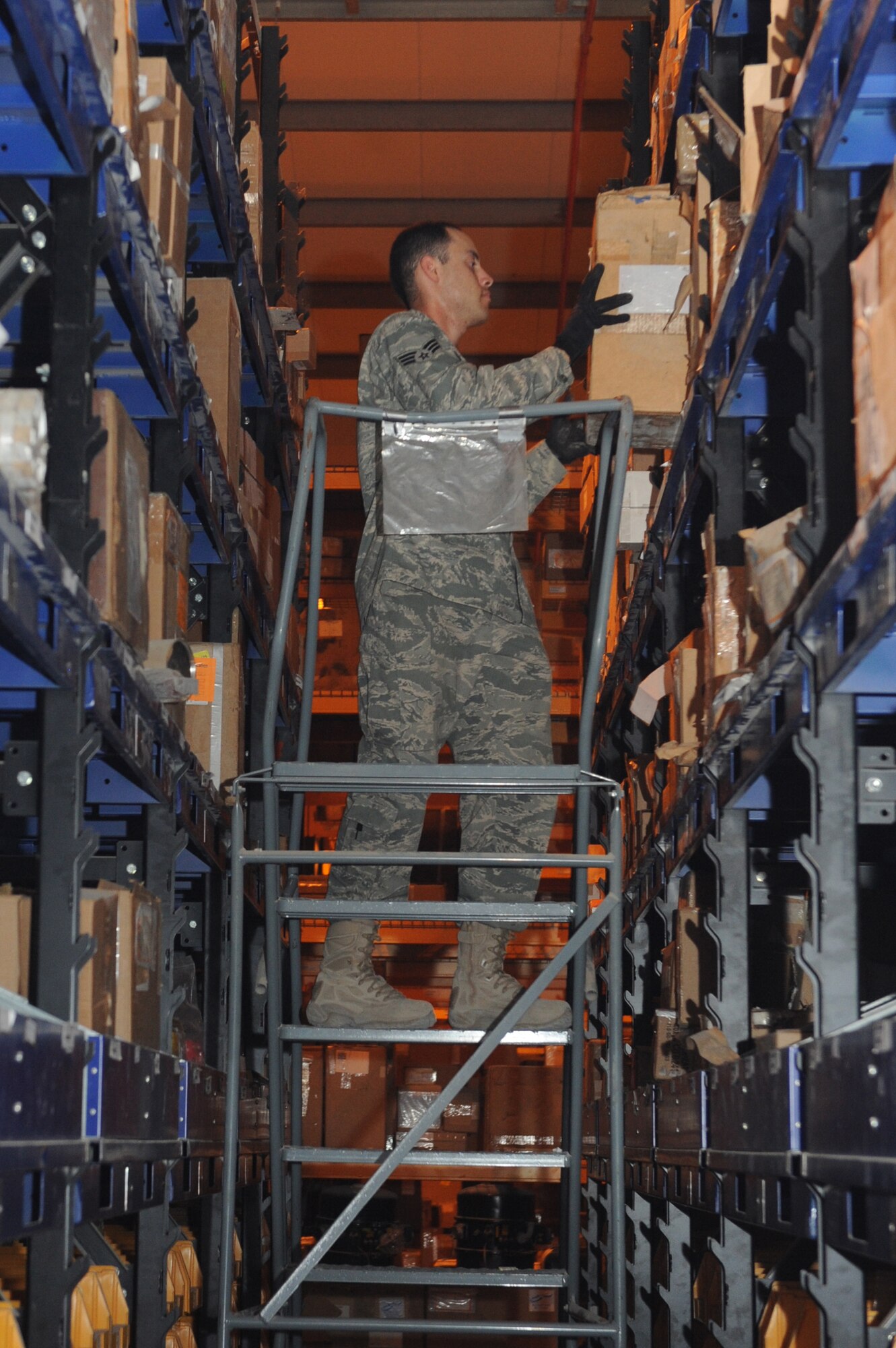 Senior Airman Elix Carrasquillo, 379th Expeditionary Logistics Readiness Squadron consolidated aircraft parts store apprentice, stocks parts in the supply warehouse at a non-disclosed Southwest Asia location, Apr 13, 2010. (U.S. Air Force photo by Tech. Sgt. Michelle Larche)[RELEASED]