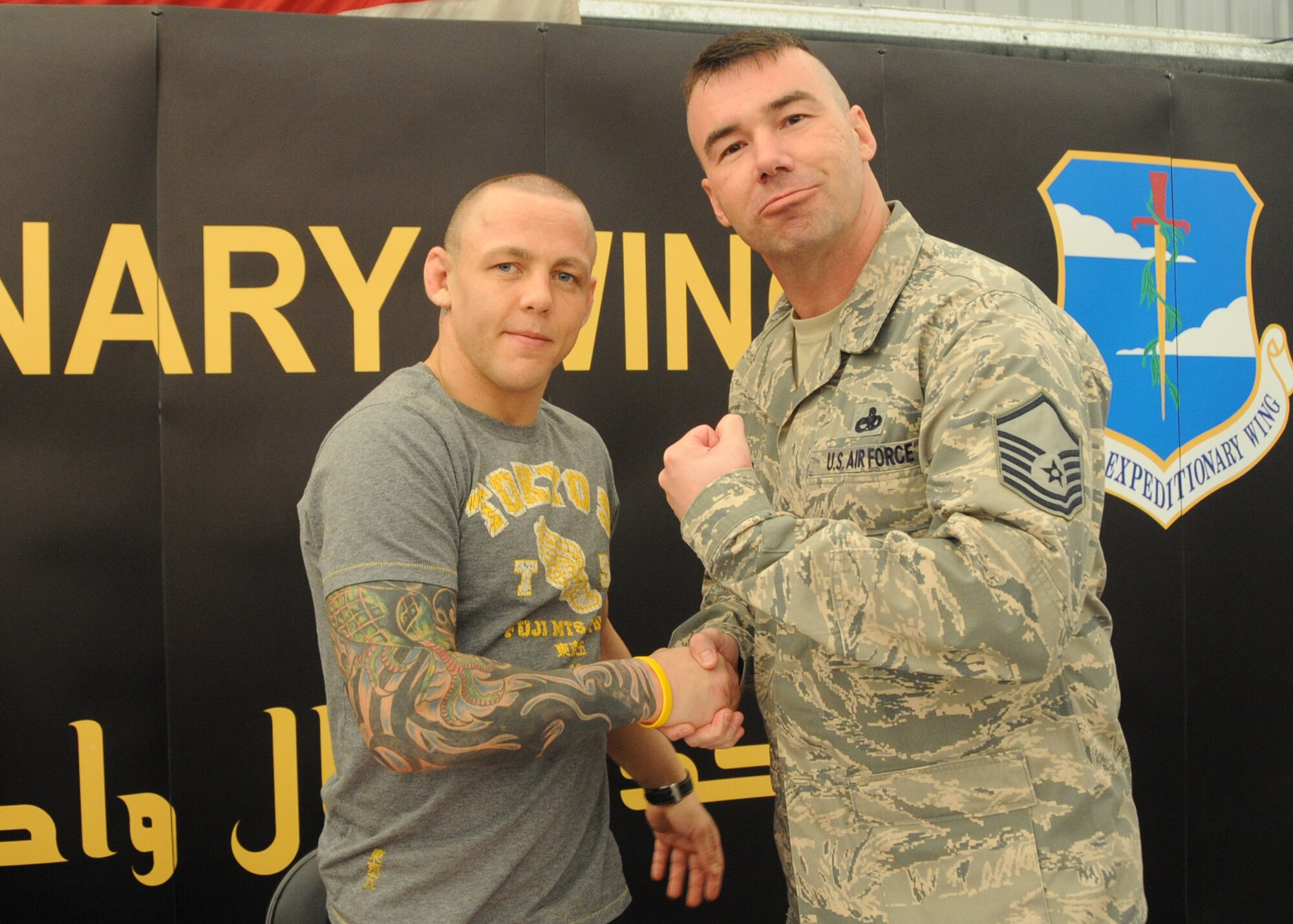 Master Sgt. Donovan Shaefer, 380th Air Exepditionary Wing safety office shakes hands with Ultimate Fighting Championship fighter Ross Pearson at an undisclosed location in Southwest Asia on April 4, 2010.The 380th AEW, supports Operations Iraqi Freedom and Enduring Freedom and the Combined Joint Task Force-Horn of Africa. The 380th AEW is comprised of four groups and 12 squadrons and the wing's deployed mission includes air refueling, surveillance and reconnaissance in support of overseas contingency operations in Southwest Asia. (U.S. Air Force photo/Senior Airman Jenifer H. Calhoun/Released)
