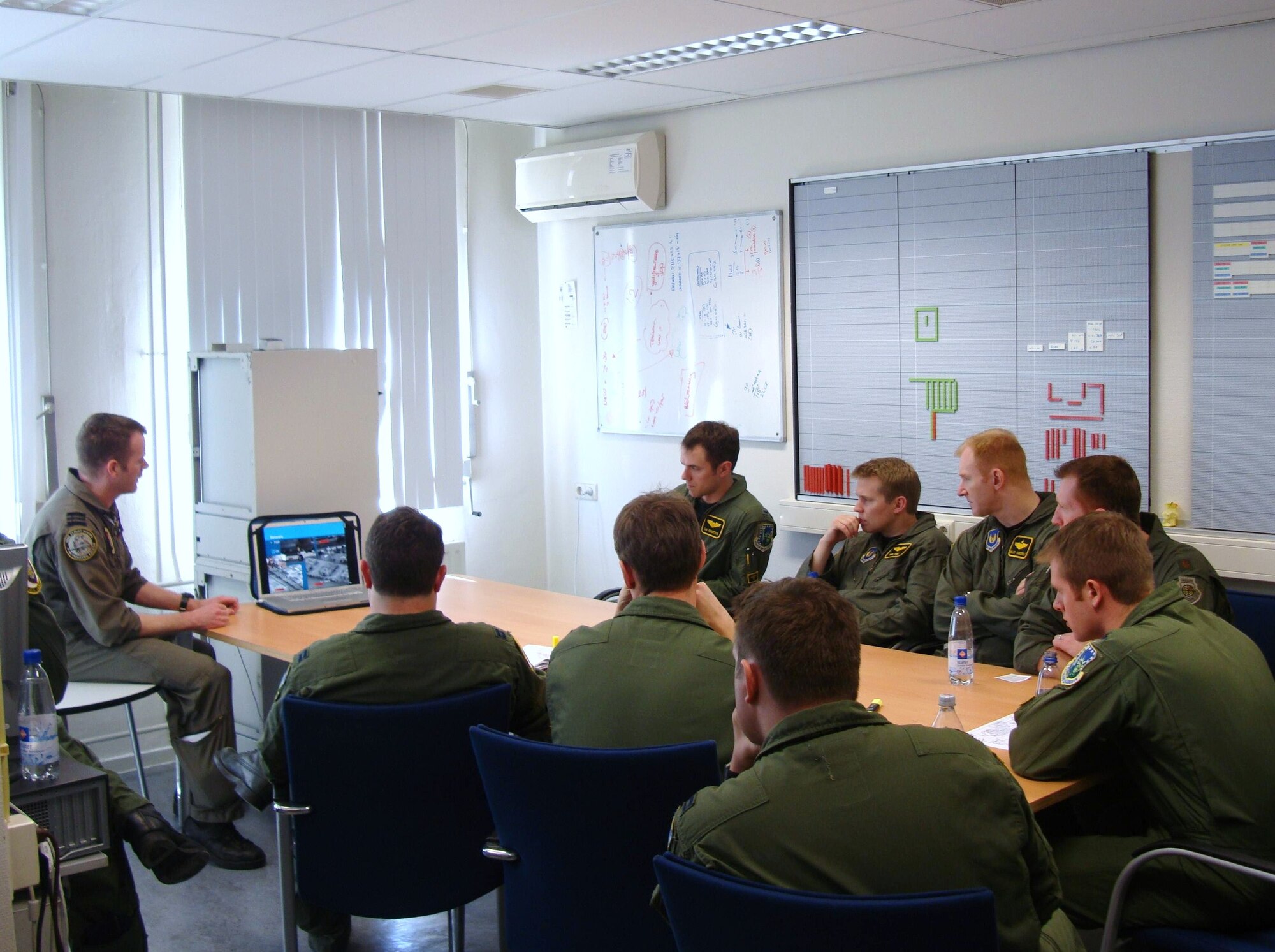 A Dutch pilot gives a group of 493rd Fighter Squadron pilots a briefing on the conflict in Afghanistan in a Squadron Weapons and Tactics Talk April 15 during FRISIAN FLAG 2010 at Leeuwarden Air Base, the Netherlands.  During briefings such as this one, pilots learn about life as a pilot in a war zone and what demands are placed on them in real-time targeting situations.  Similar to the RED FLAG exercise at Nellis Air Force Base, Nev., personnel and aircraft from several nations participate in FRISIAN FLAG to train on large-scale integration and combat scenarios. (U.S. Air Force photo/1st Lt. Haley Ageton)