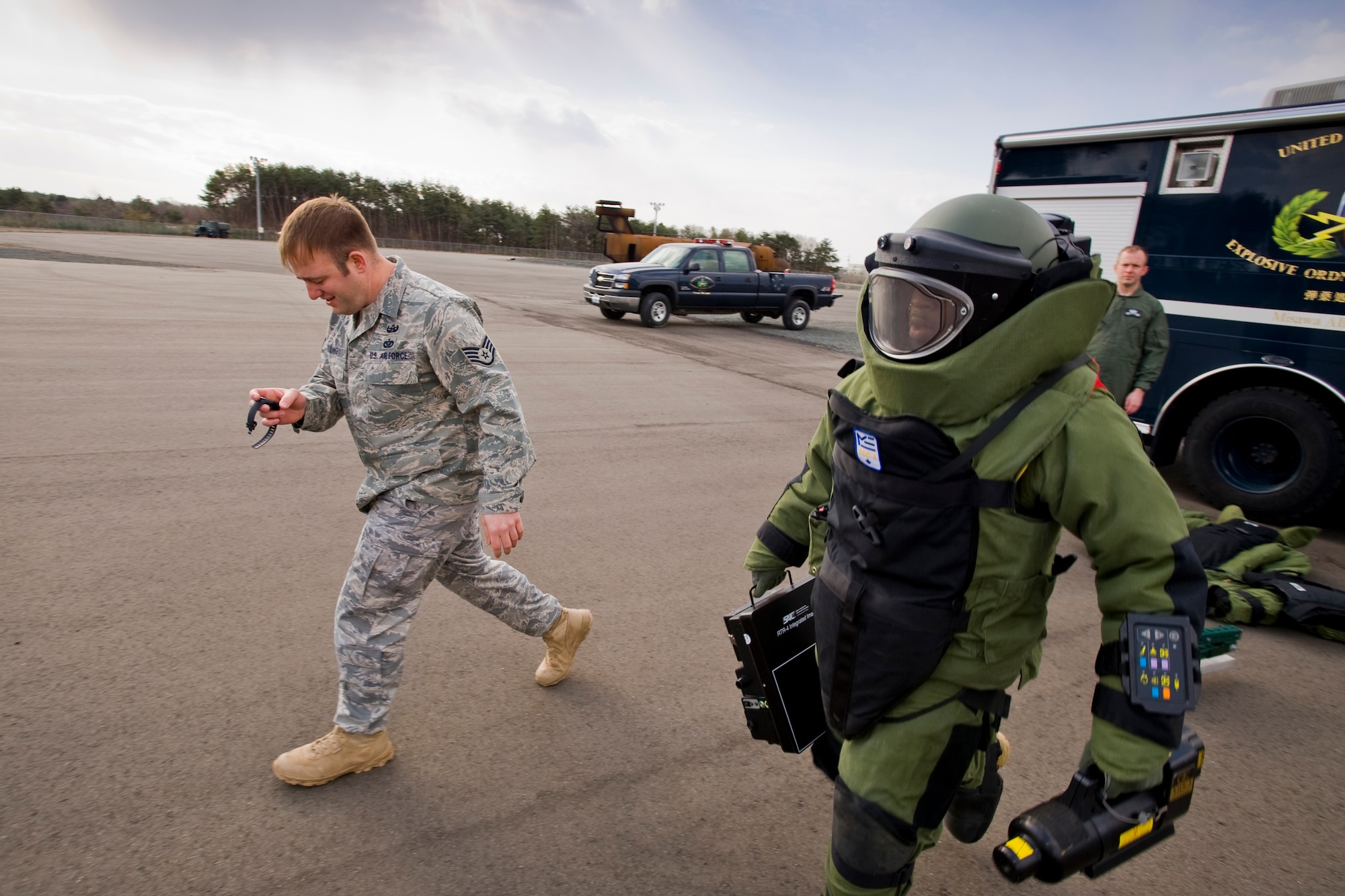 MISAWA AIR BASE, Japan -- As Staff Sgt. Anthony Walling, 35th Civil Engineer Squadron explosive ordnance disposal craftsman, starts his timer, Staff Sgt. Michael Overton, 35th CES EOD craftsman, begins course during a bomb-suit stress drill April 15 at the Misawa Fire Emergency Services Training Center. In addition to the physical stress added by the 70-pound bomb-suit, the timed drills test the members' ability to work quickly and safely in sensitive situations. (U.S. Air Force photo/Senior Airman Jamal D. Sutter)