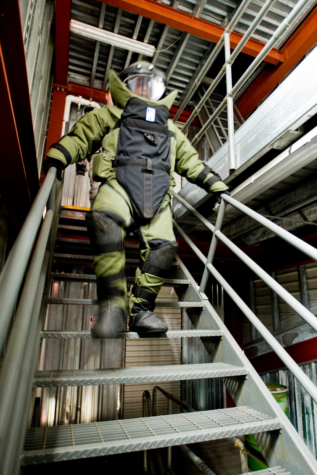 MISAWA AIR BASE, Japan -- Airman 1st Class Jason Wayne, 35th Civil Engineer Squadron explosive ordnance disposal journeyman, races downstairs through the Misawa Fire Emergency Services Training Center during a bomb-suit stress drill April 15. During the drill, EOD members carried equipment and performed a memory test, simulating gathering intelligence and evidence. (U.S. Air Force photo/Senior Airman Jamal D. Sutter)
