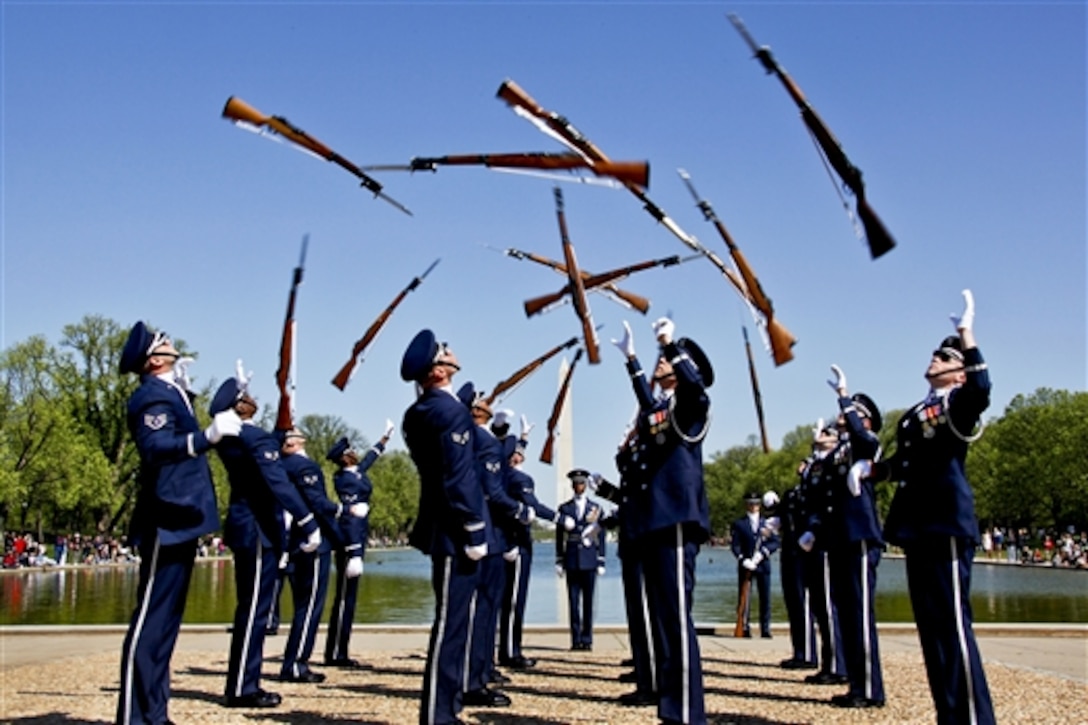 U.S. Air Force airmen in the U.S. Air Force Honor Guard Drill Team prepare to catch their rifles during their routine for the Third Annual Joint Service Drill Exhibition in Washington, D.C., April 10, 2010. More than 4,000 people came to the steps of the Lincoln Memorial to watch five teams demonstrate military drills.