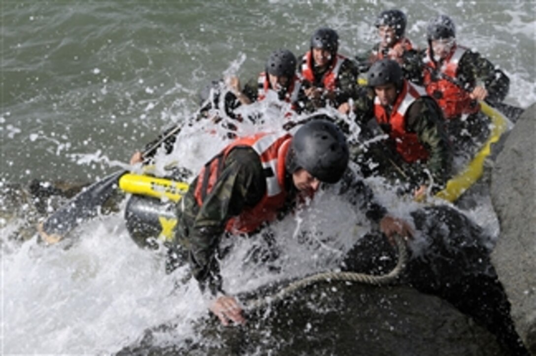 Students in Basic Underwater Demolition/SEAL Class 282 participate in rock portage in Coronado, Calif., on April 13, 2010.  Rock portage is a training cycle designed to challenge individual skills and teamwork as students struggle to get their inflatable boat safely ashore.  