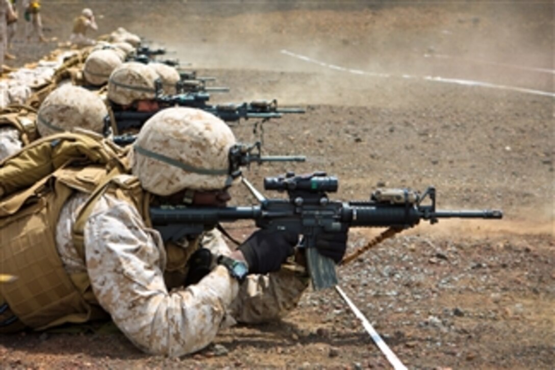 U.S. Marine Corps Staff Sgt. Reginald Gibbons, Headquarters Battery, 1st Battalion, 12th Marine Regiment, fires his M-4 carbine from the prone position during the Table 3 firing exercise held at Range 8C, Pohakuloa Training Area, Hawaii, on April 11, 2010.  During the exercise Marines practice various firing drills to simulate combat scenarios on targets presented at known and unknown distances.  