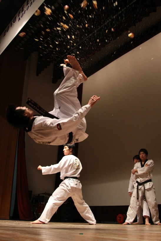 Yechon Air Base, REPUBLIC OF KOREA - A tae kwon do student on the Kyung Hee University Demon Team the kicks an apple as he does a back flip during the Exercise Foal Eagle 2010 Korean - U.S. Friendship Event at the theater here April 16. The team awed the audience with their routine of kicks and flips.