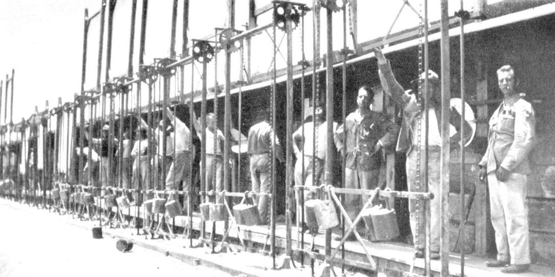 Recruits from the 1930's work the pits - then called the butts - and mark targets with the shot spotters. Almost 80 years later, the procedure for pulling targets is nearly unchanged.