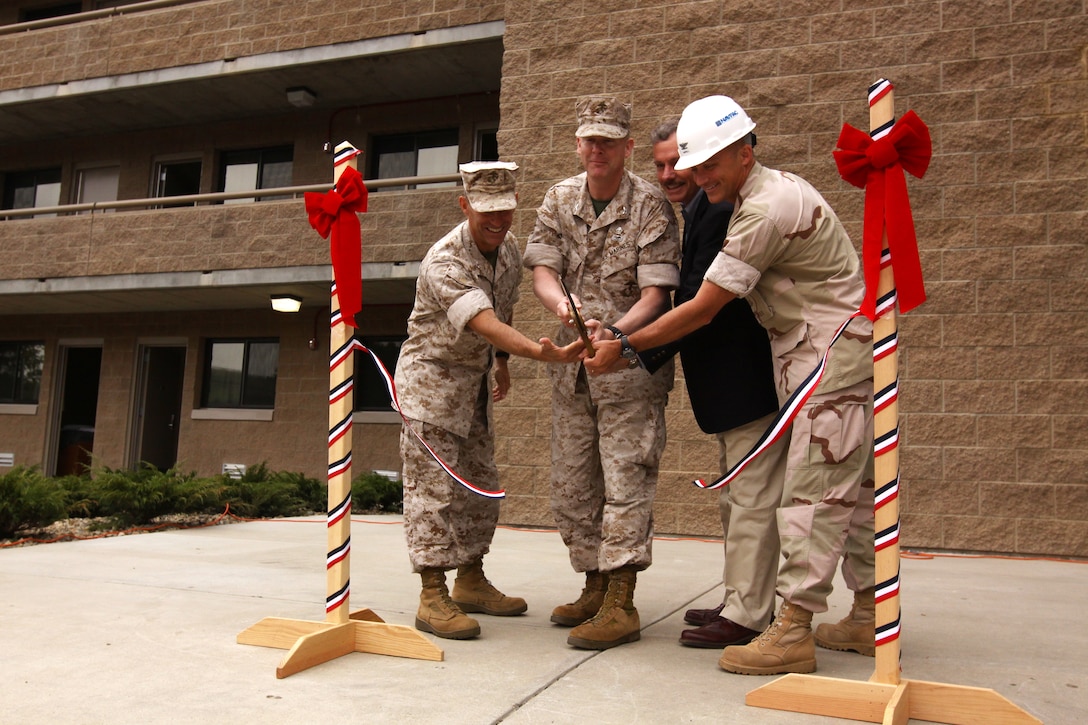 (Left to right) Col. Nicholas F. Marano, commanding officer, Marine Corps Base Camp Pendleton; Col. Brennan T. Byrne, commanding officer, School of Infantry West; David Roach, senior vice president, Barnhardt Balfour Beatty Inc.; Navy Capt. Joseph A. Campbell, commanding officer, Officer In Charge of Construction Marine Corps Installations West; open Camp Pendleton’s newest barracks at the SOI West, April 14. The $9 million billeting facility is the first building on base to be fully funded by President Barrack Obama’s 2009 American Restoration Recovery Act. The presidential act is designed to reinvest government spending into local communities to create jobs.