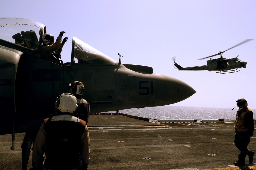 Lt. Col. Robert Fails, Marine Attack Squadron 311 detachment commander, exits an AV-8B Harrier on the flight deck of the USS Peleliu as a UH-1N Huey helicopter flies by April 16, 2010. Six Harriers and approximately 80 squadron Marines left Yuma April 15 to participate in their third and final predeployment training evolution off the coast of California. The exercise, which began April 16 and is scheduled to end April 27, included the entire 15th Marine Expeditionary Unit. The squadron is slated to deploy to the Pacific and Indian Oceans with the 15th MEU in May. The remainder of the squadron deployed to Japan aboard the USS Essex with the 31st MEU in January. The last time the squadron deployed with the 15th MEU was in 2008.