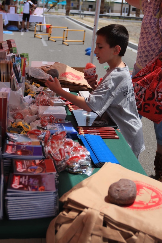 MARINE CORPS AIR GROUND COMBAT CENTER TWENTYNINE PALMS, Calif. - David Horbal, 8, helps himself to free bracelets and school supplies from the Drug Prevention Education booth during the Family Fun Fitness Festival at the Commissary and Home Store parking lot April 17. The festival promoted healthy lifestyles by providing resources to Combat Center family members on how to be mentally and physically fit.