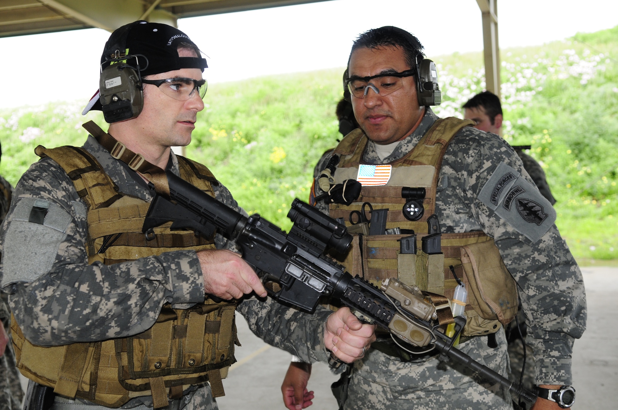 NASCAR driver Jeff Gordon receives tips on weapons handling while suiting up with National Guard Security Forces Soldiers in Texas, on April 15, 2010. (U.S. Air Force photo by Senior Master Sgt. Mike Arellano/Released)