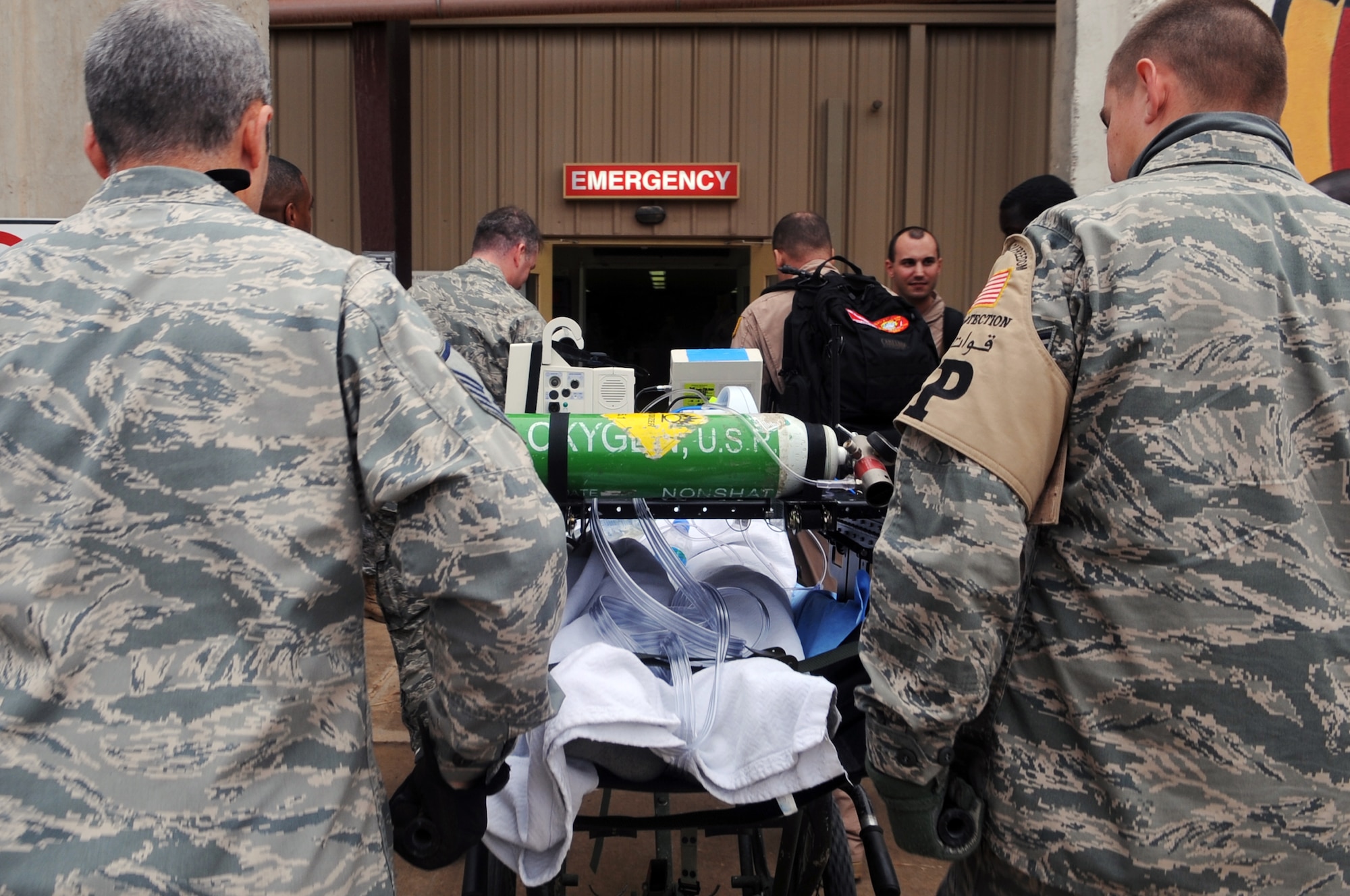 332nd Expeditionary Medical Group personnel transport a patient inside the Air Force Theater Hospital during an aeromedical evacuation mission at Joint Base Balad, Iraq, April 17, 2010. The 332nd EMDG is expecting about five aeromedical evacuation missions a week from Afghanistan, plus select in-system flights that will be flown as needed. (U.S. Air Force photo/Senior Airman Brittany Y. Bateman/Released)