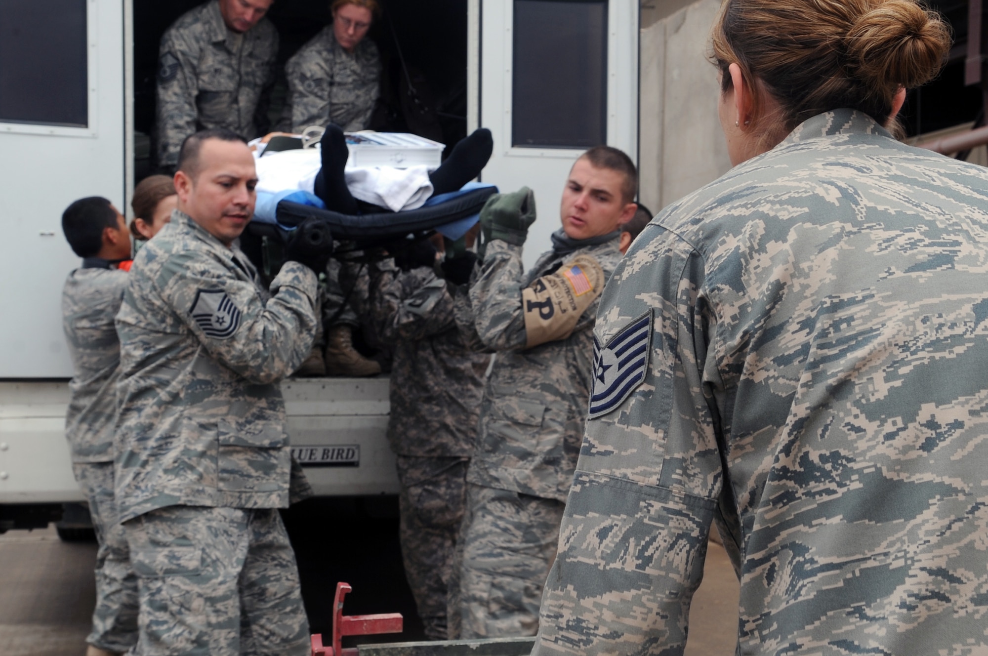 Personnel from the 332nd Expeditionary Medical Group unload a patient from a bus to be transferred to the Air Force Theater Hospital during an aeromedical evacuation mission at Joint Base Balad, Iraq, April 17, 2010. The 332nd EMDG is expecting the average patient load to increase by about 50 patients per day.  (U.S. Air Force photo/Senior Airman Brittany Y. Bateman/Released)