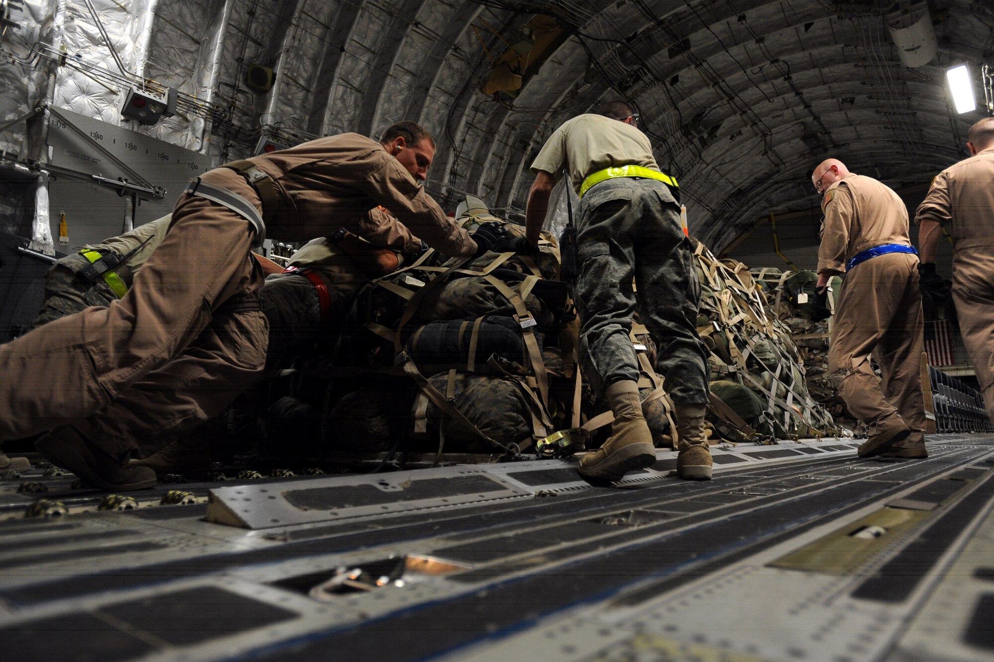 Aerial porters assigned to the 451st Expeditionary Logistics Readiness Squadron, Detachment 1 and C-17A Globemaster III loadmasters assigned to the 816th Expeditionary Airlift Squadron, load pallets of luggage that belong to 157 Marines boarding the aircraft, April 15, 2010, at Camp Bastion, Afghanistan. (U.S. Air Force photo/Staff Sgt. M. Julian Martinez/released)