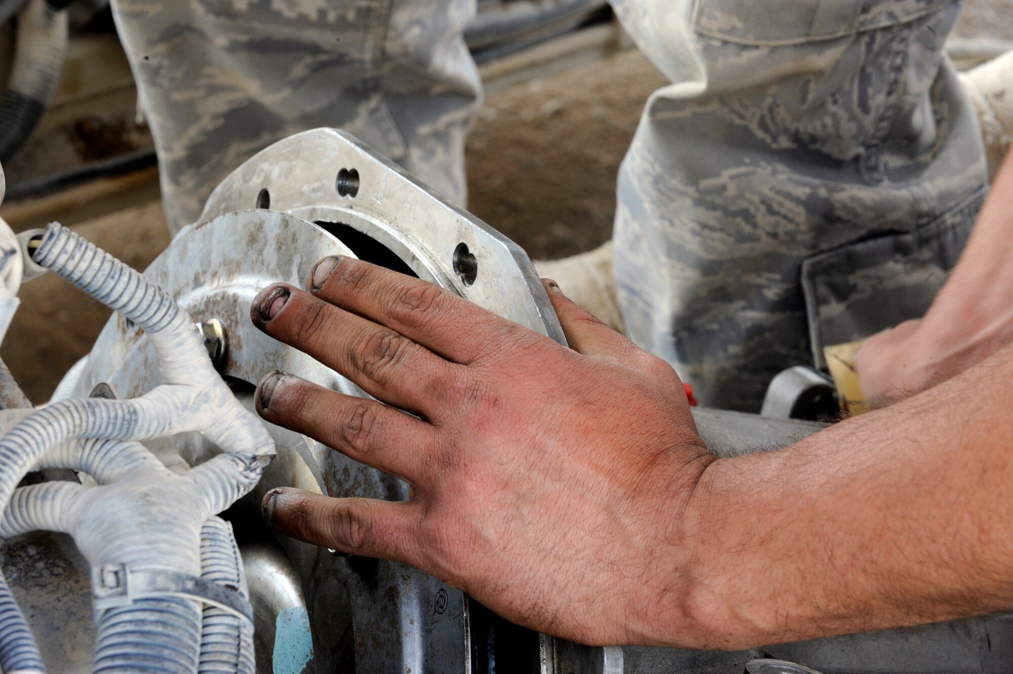 Staff Sgt. Joshua Schuldt, a vehicle maintainer assigned to the 451st Expeditionary Logistics Readiness Squadron, Detachment 1, helps install a transmission in a 25k fork lift April 15, 2010, at Camp Bastion, Afghanistan. (U.S. Air Force photo/Staff Sgt. M. Julian Martinez/released)